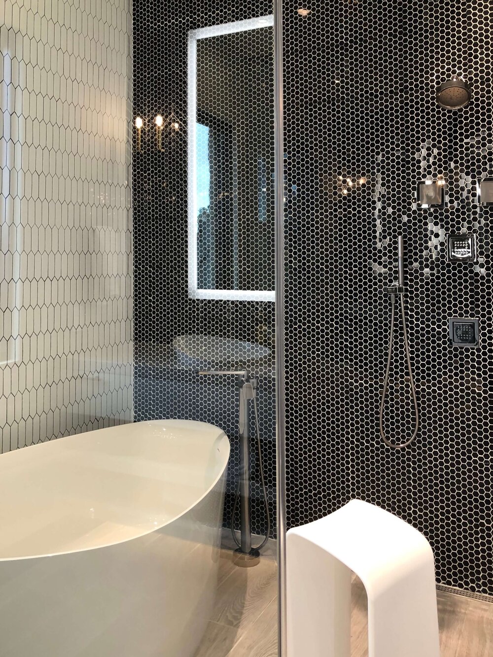 Free standing tub placed in large shower stall in The New American Remodel. TNAR | #remodeling #remodel #masterbathideas