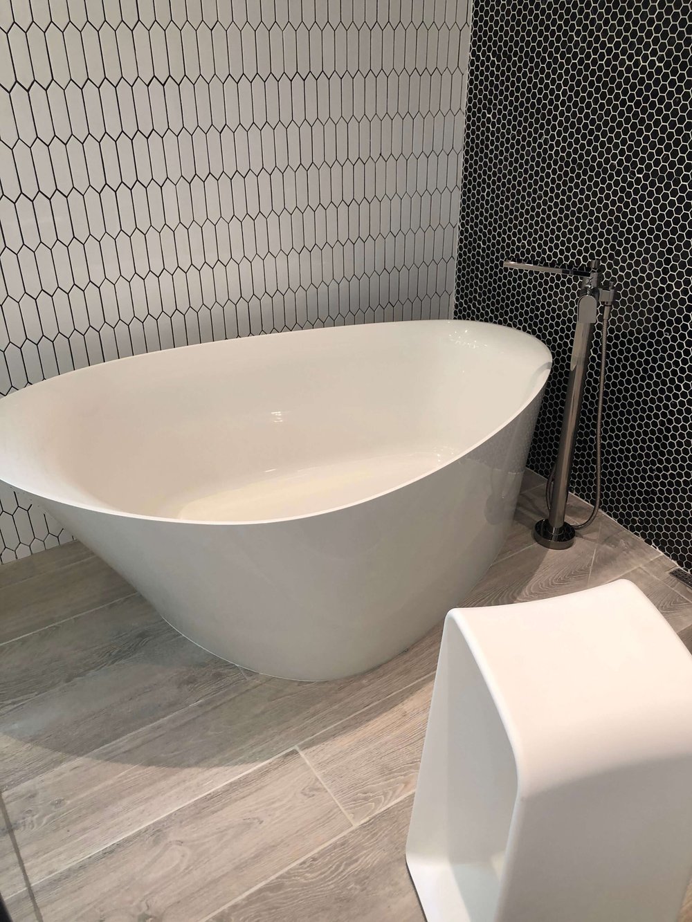 Free standing tub placed in large shower stall in The New American Remodel. TNAR | #remodeling #remodel #masterbathideas