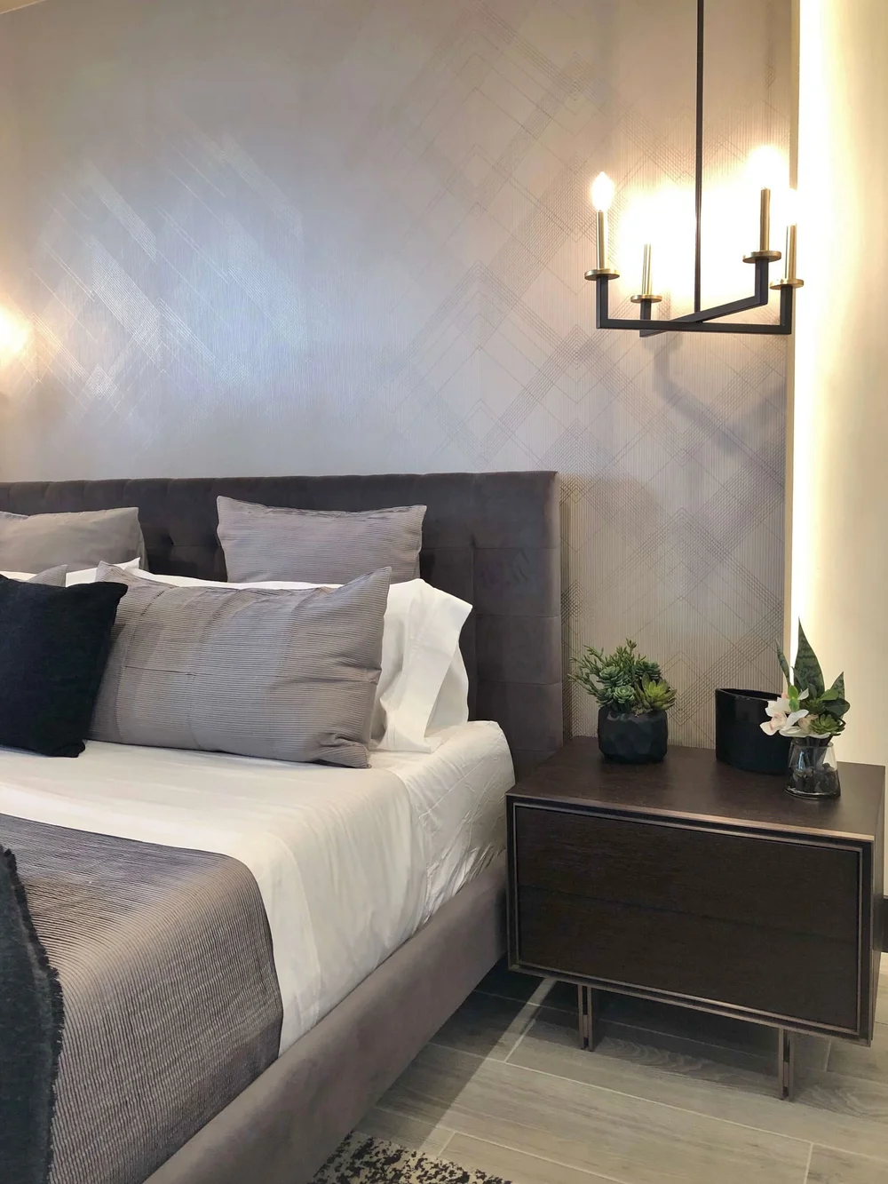 The master bedroom had an interesting wallcovering wrapping a dummy wall that was lit from behind. The New American Remodel TNAR | #remodeling #remodel #graybedroom