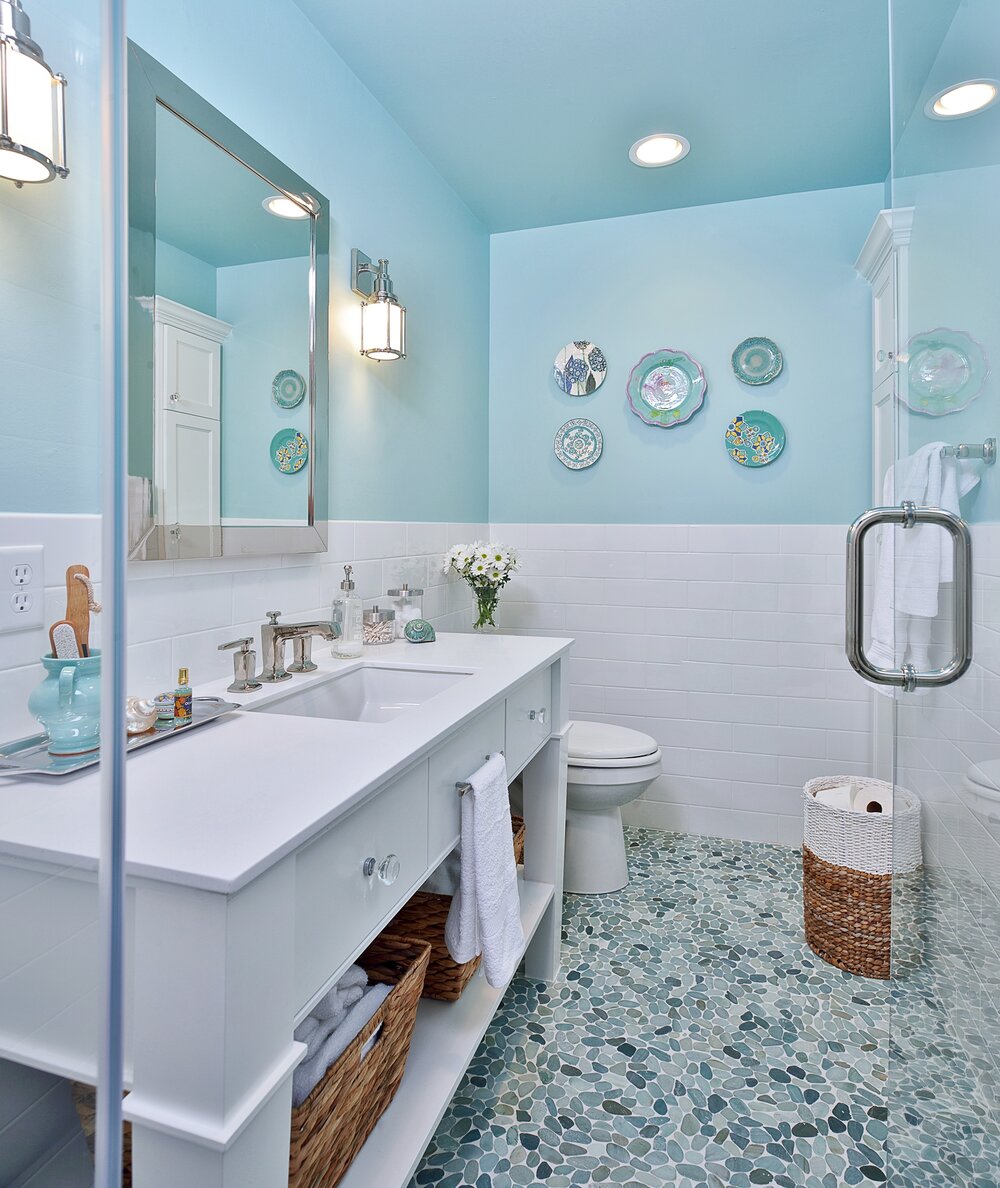 Feminine bathroom in Tiffany blue with pebble tile floor and custom vanity for a girl’s bathroom. Carla Aston, Designer | Miro Dvorscak, Photographer