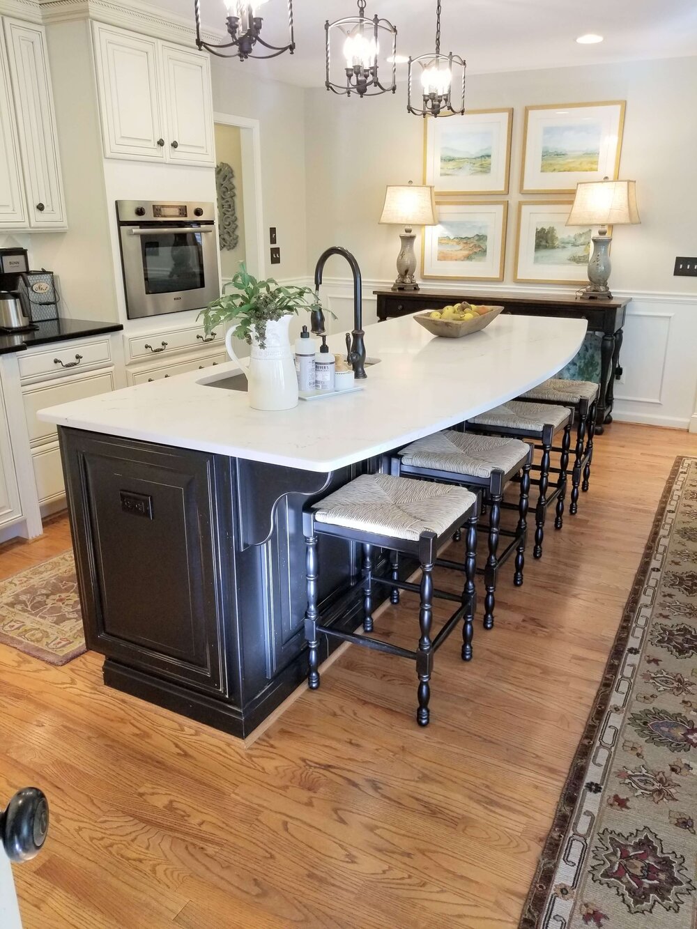 AFTER - The new quartz countertop on the island only, brightened up this kitchen and brought it up to date. The black granite remained on the perimeter cabinets.