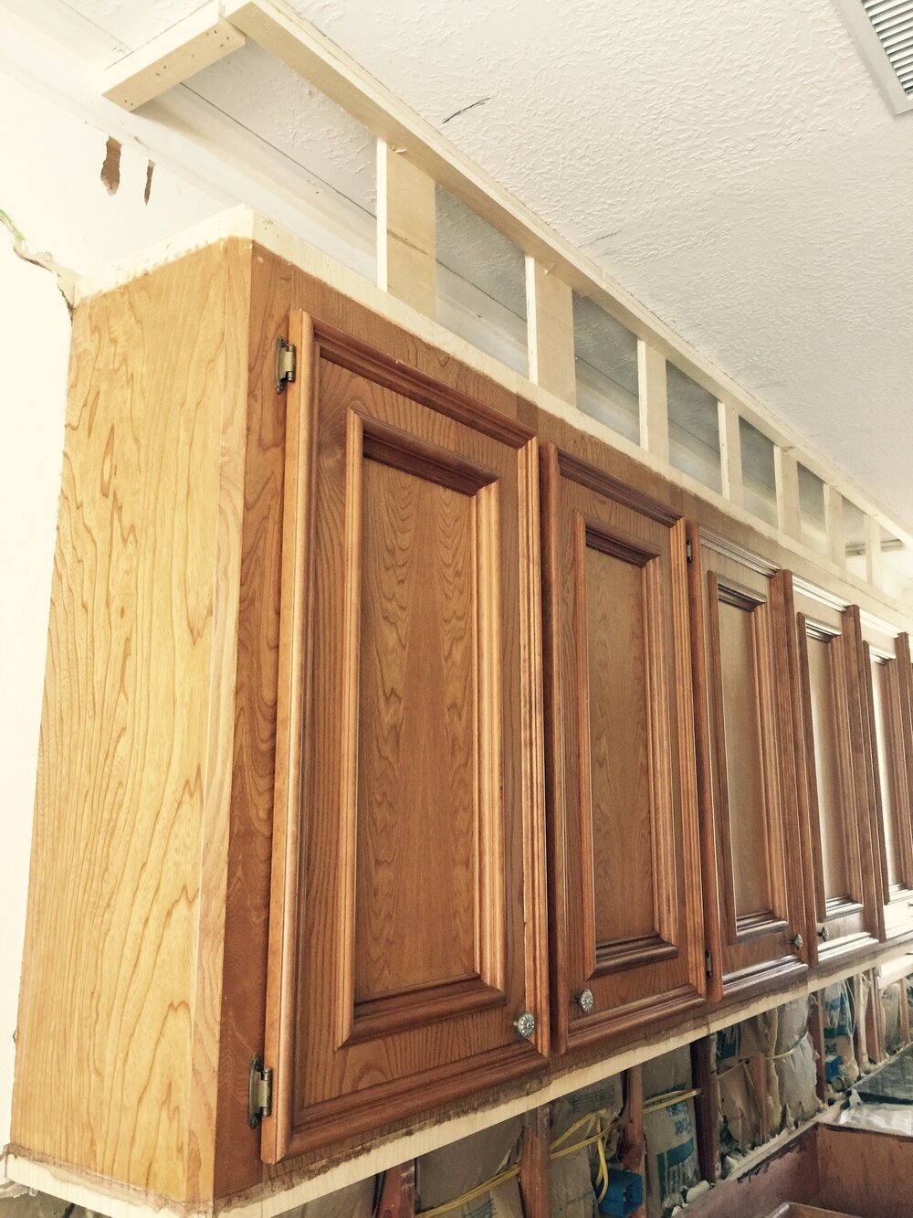 During Construction - the upper section was boxed in and new mouldings were applied to get a taller upper cabinet look.