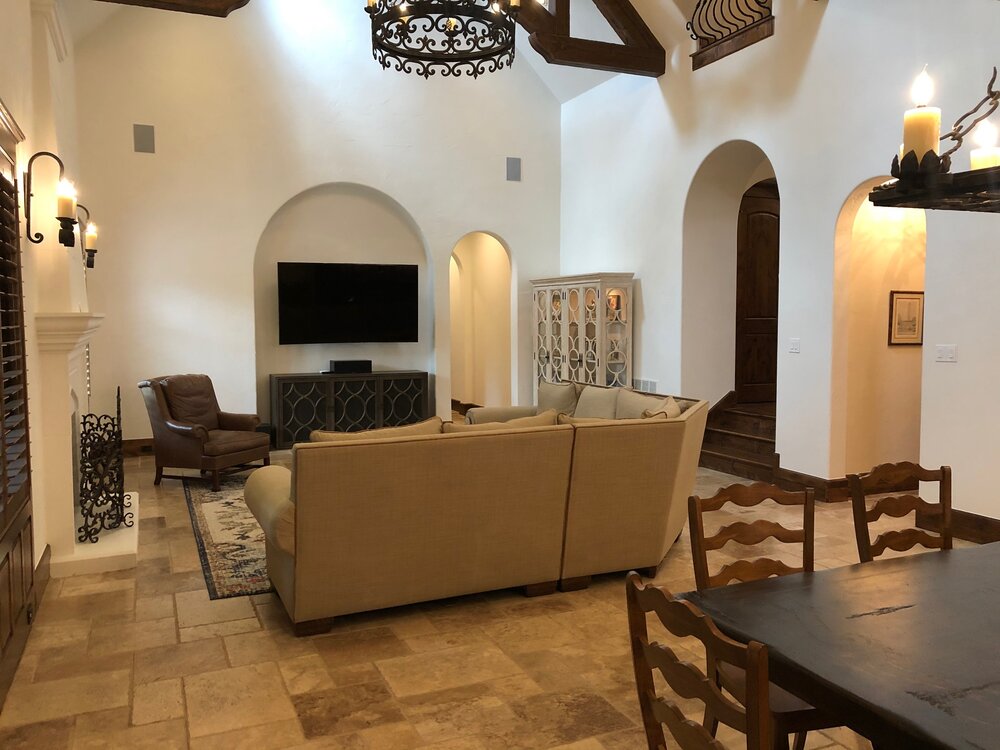 Benjamin Moore White Dove lightened up this formerly dark Tuscan style home with a large great room and open kitchen.