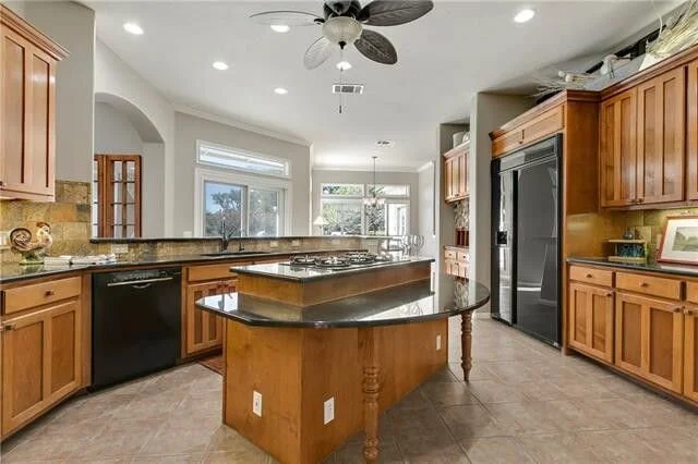 BEFORE  - Kitchen Remodel | An odd island, dated finishes made this kitchen feel dark and closed off from the main living space.