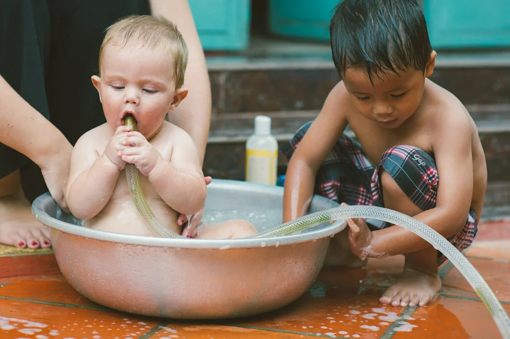 We do not approve of babies sucking on hose spouts, but I had to capture the moment first!
