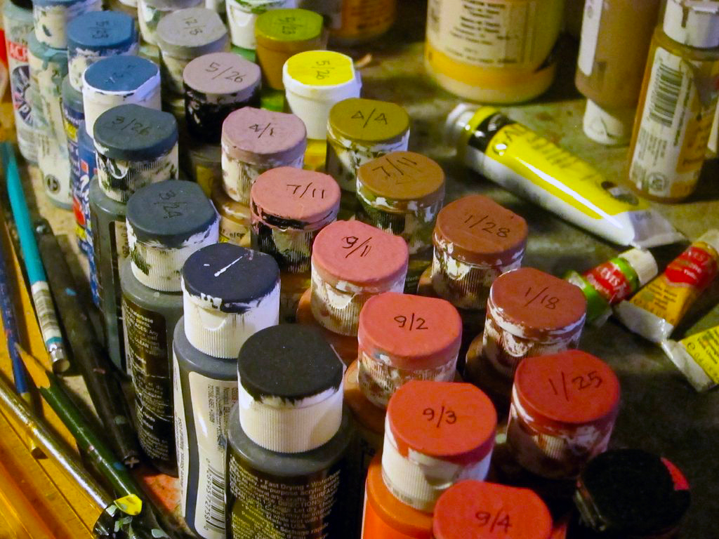 Organized paints, with the colours and dates indicated on the cap.