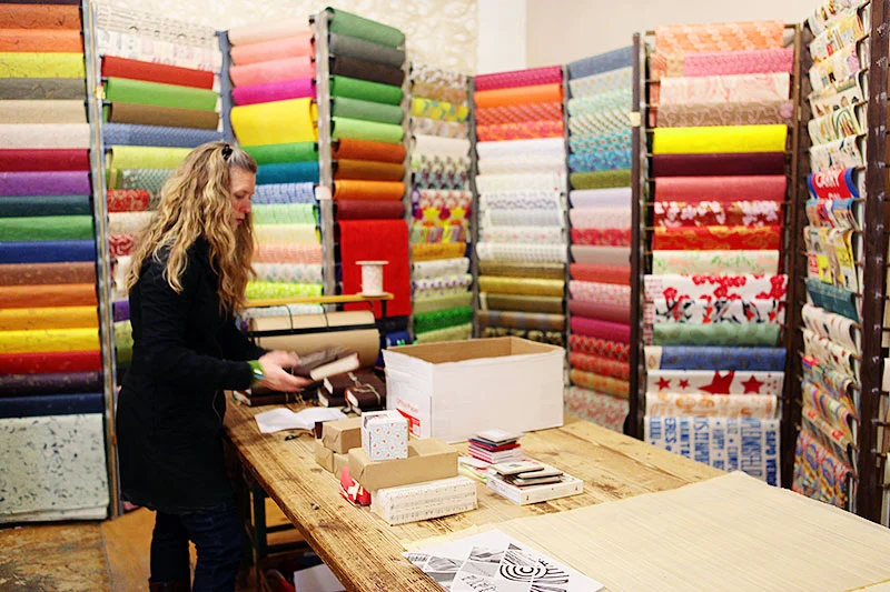 Proprietor Mia Semingson unpacks some new inventory.