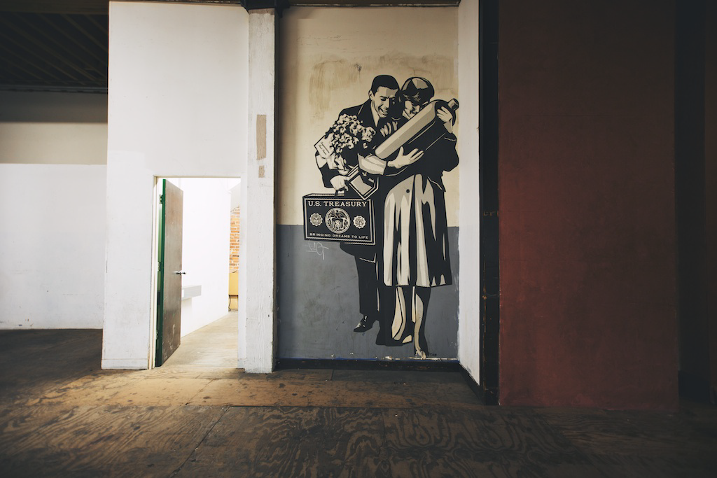 This wheat paste street art is a Shepard Fairey piece left over from when he had his studio there years ago.