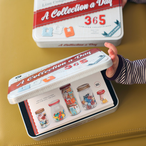 Finley opens the tin to reveal the book inside.