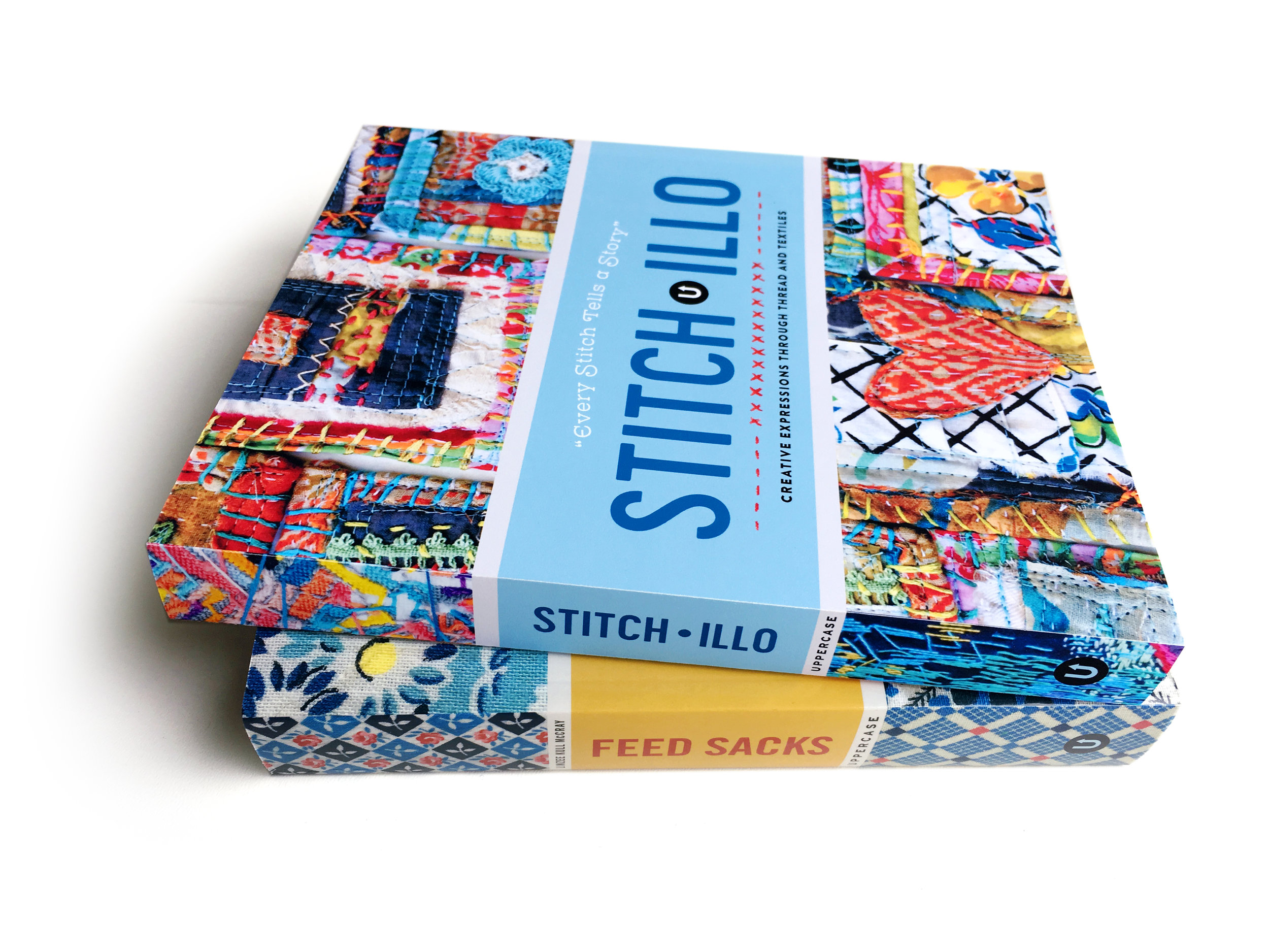 Stitch•illo pictured with a printed copy of Feed Sacks: The Colourful History of a Frugal Fabric (text by Linzee Kull McCray)