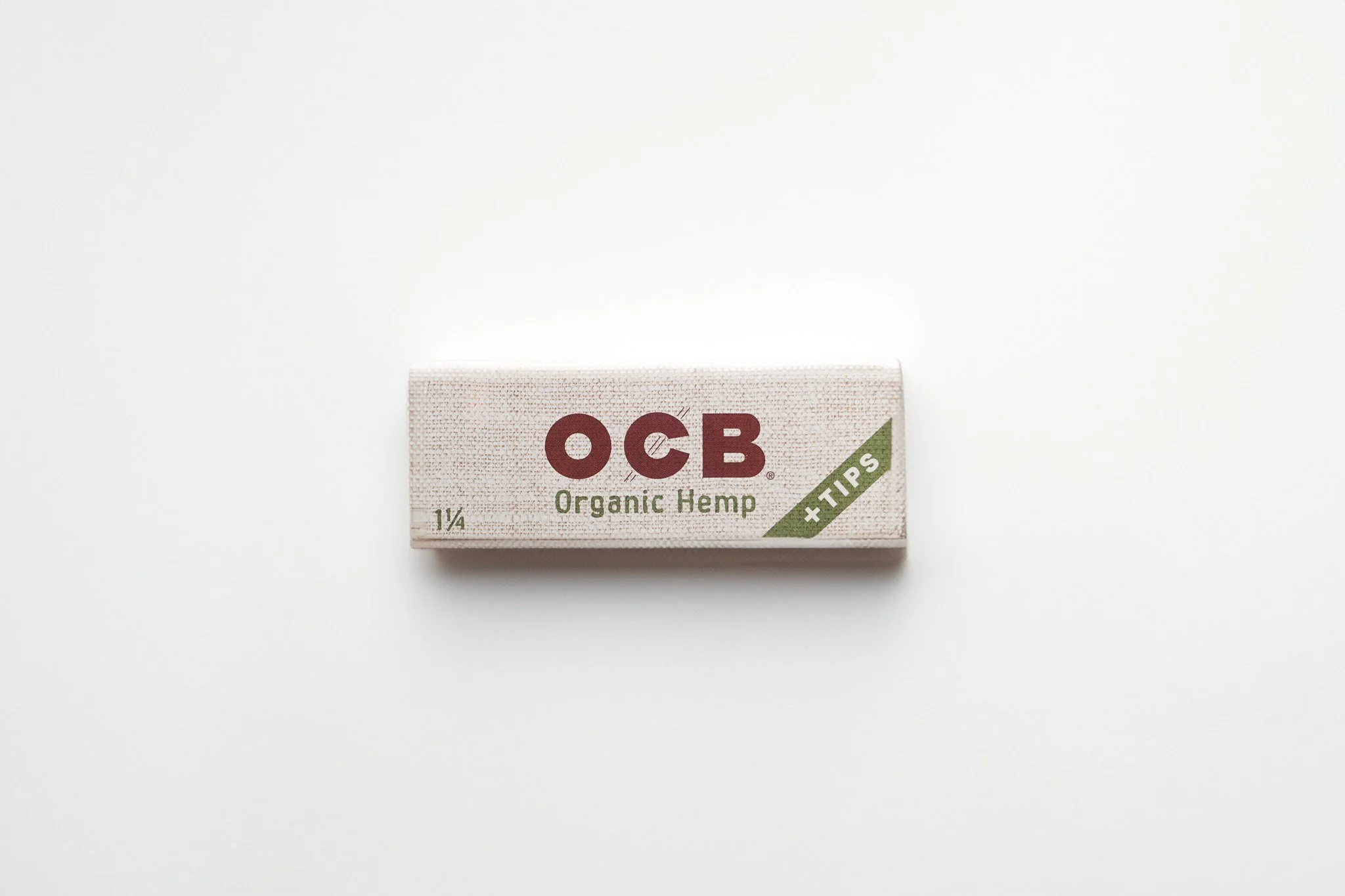 A box of OCB Organic Hemp rolling paper tip has a white background with green and red text.