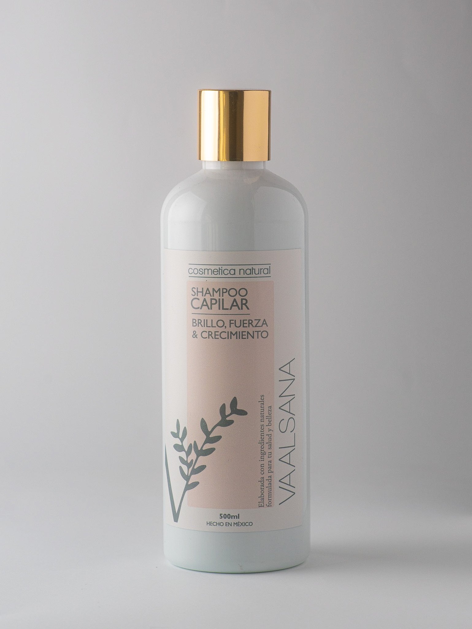 A white bottle of hair shampoo with a gold cap, labeled 'VIALSANA' and 'SHAMPOO CAPILAR,' with a coral pink label, featuring a stylized leafy branch illustration.