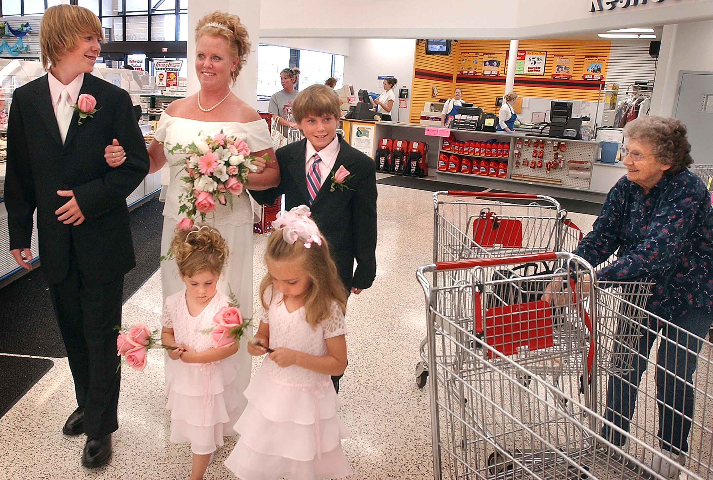  Diane Roderick drew a bit of attention on a Saturday at the HyVee grocery store in Quincy, Il. as she prepared to go down the aisle. Her sons Stuart Roderick, left, and Spencer Roderick, right, accompanied their mother and flower girls Morgan Fleer,