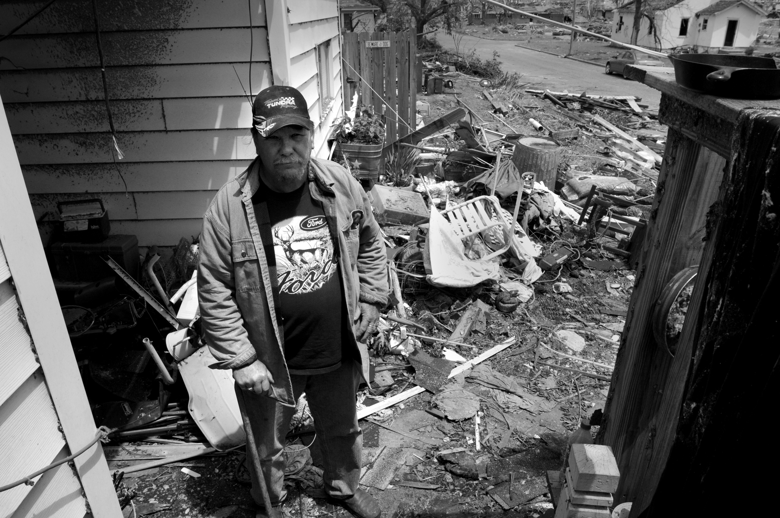Fred Coombes stands in his yard in Joplin, Mo. after one of largest tornadoes in the United States destroyed his home and property.
