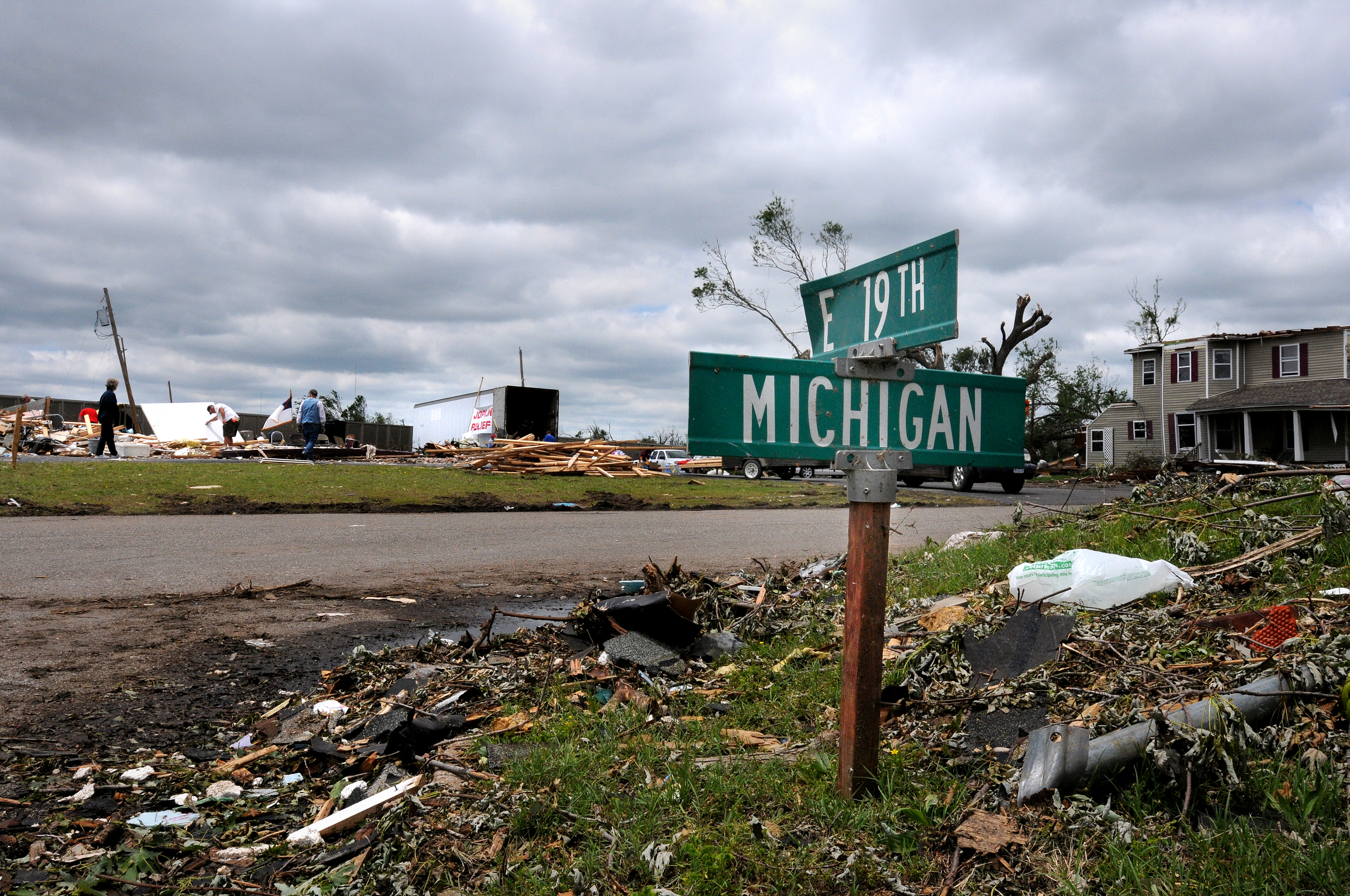 A Joplin, Mo. street sign is stuck in the ground to help identify the location after an E5 tornado destroyed most buildings, streets and signs that indicated locations.