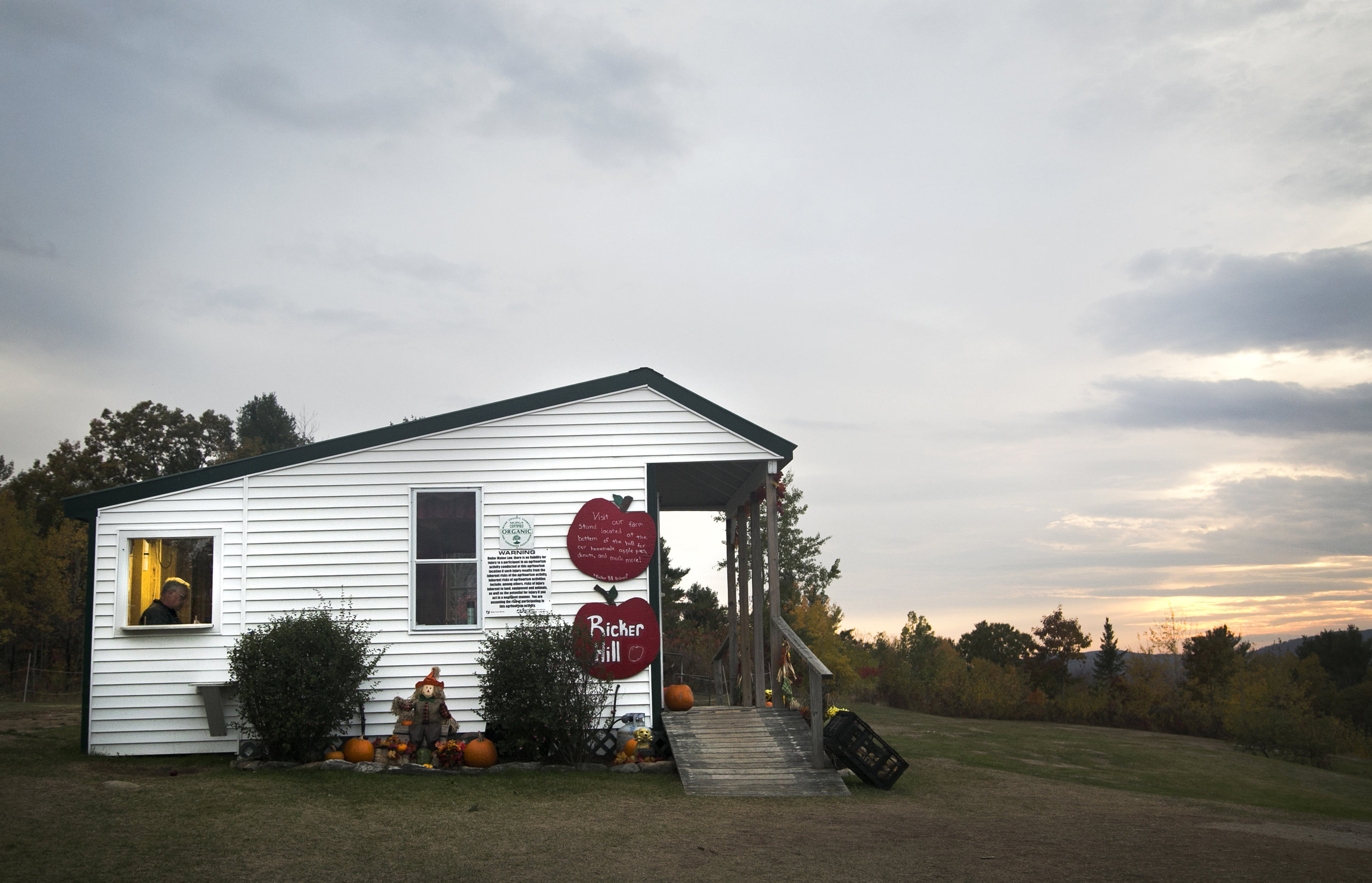 Bill Ricker, owner and operator of Ricker Hill Orchards, closes the books for the night in Turner, Maine.