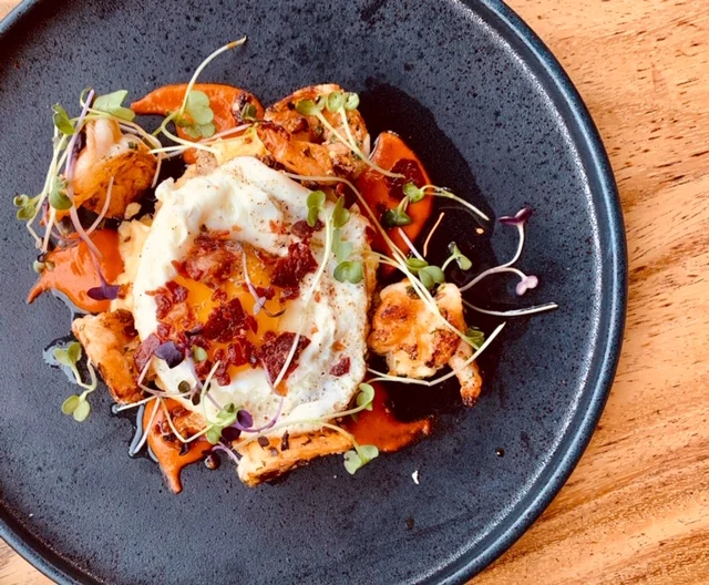 Garlic Shrimp: Sunny Side Egg, Manchego Polenta, Crispy Ham, Ibérico Brown Butter, Chilis, Salsa Brava
