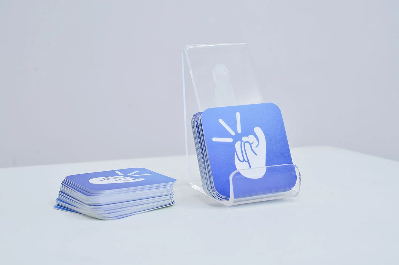 The plastic base is for placing a phone to experience the app and the cards have links and QR code for Android and iOS downloads.