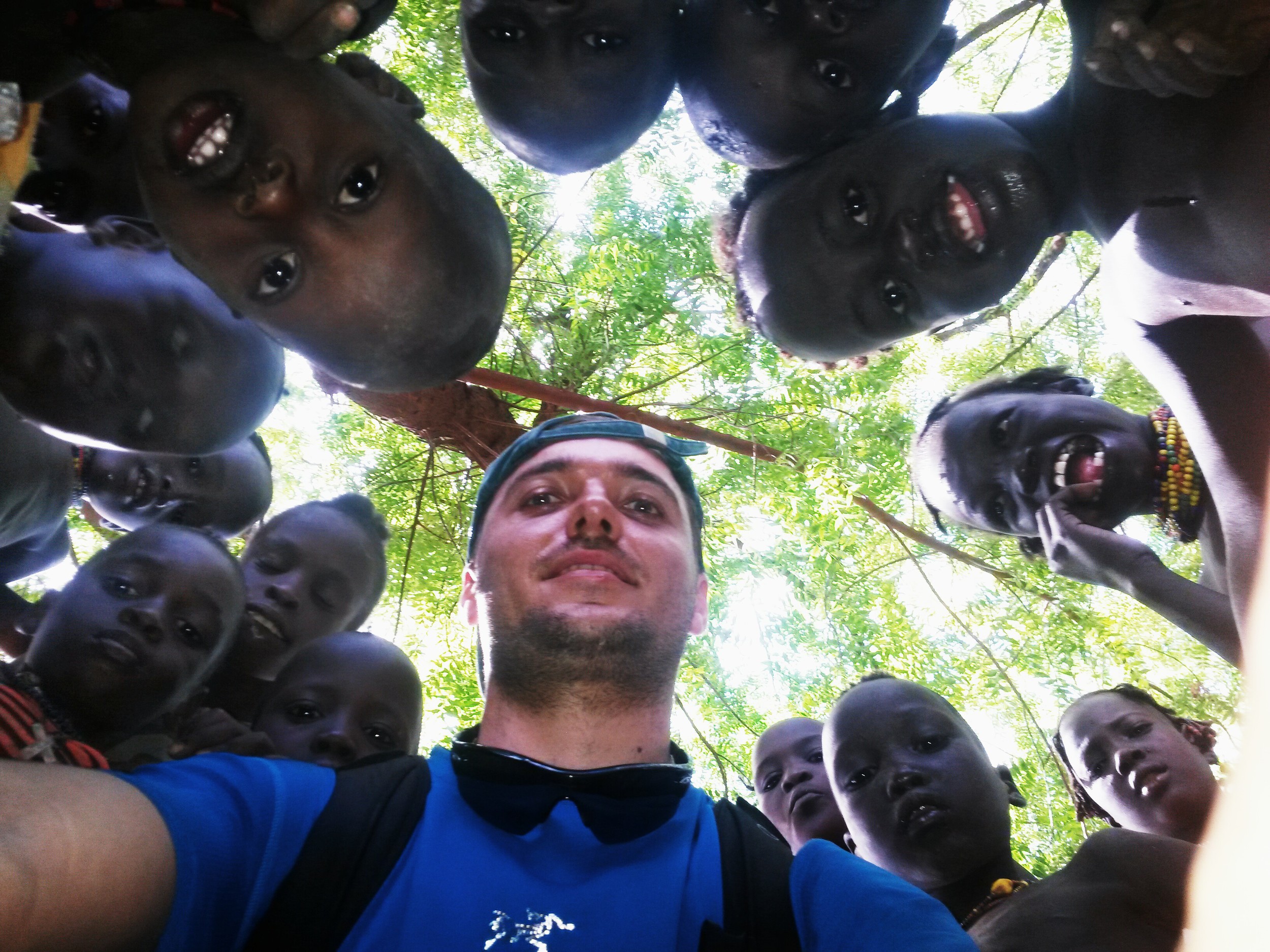 Georgi surrounded by the kids of Daasanach tribe, Lower Omo Valley, Ethiopia