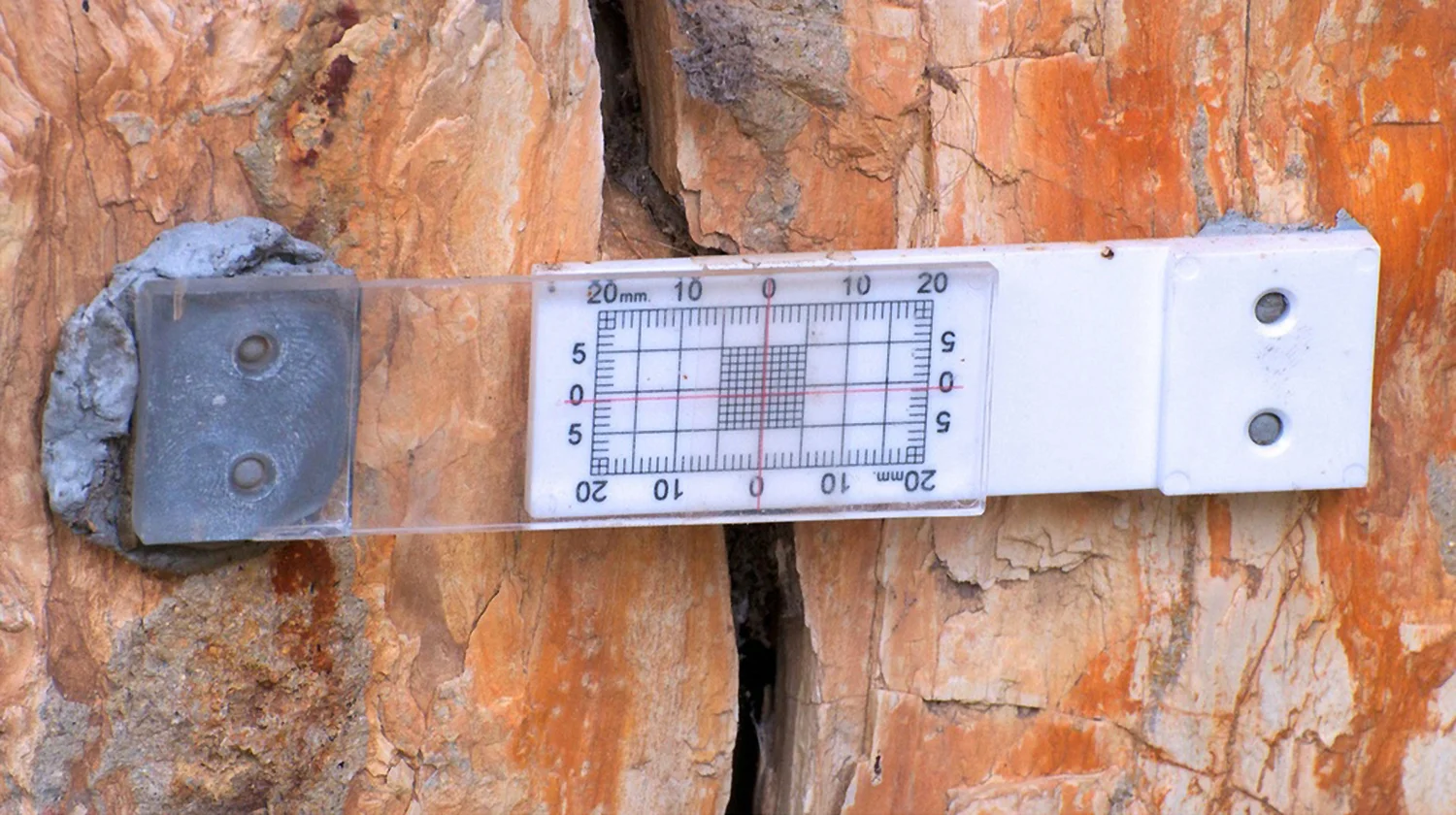 Figure 1. Buildera CRACKMON® crack monitor tracks changes in crack width of this petrified tree trunk at the Florissant Fossil Beds National Monument in Colorado. Photo credit: Lynn Bashaw.