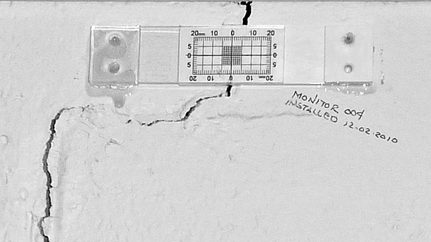 Figure 15. Crack monitor measures wall crack. Photo Credit: Wolfram