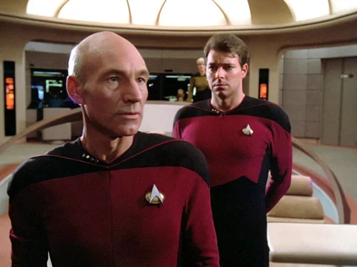 Riker’s decision may have been influenced by a love of bald men and English accents. Just look at the admiration going on right here.