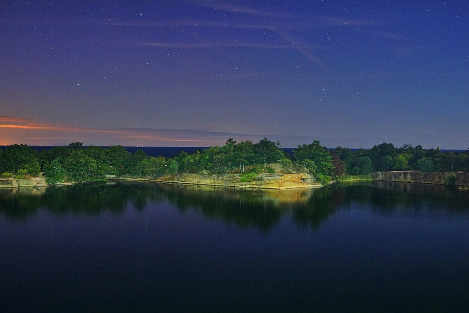 The lake in the park.looking closely you can spot flashlights behind the trees exploring the area