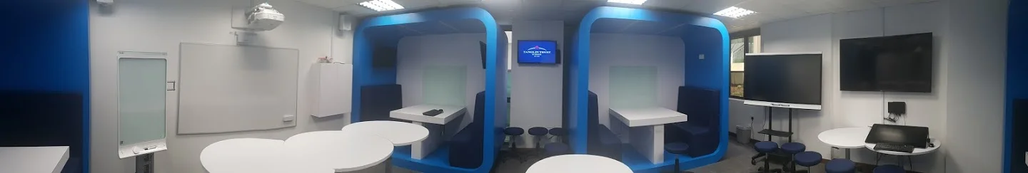 Panorama of the new (unlit) room. Left to right: SMART KAPP board, Epson multi-touch projector, PC (in box), Apple TV, ChromeCast, Twin monitors in booths, Samsung 360° Camera in ceiling, SMART 4k Panel, Samsung smart TV, Wacom Cintiq + PC. Not shown custom PC for HTC Vive VR st up.