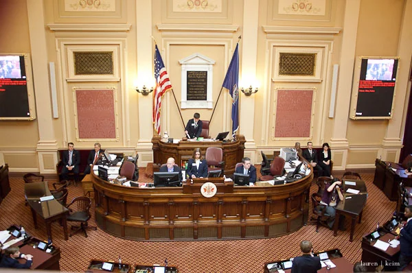 in this photo, Cal's roommate (near-center bottom right) stands to defend his bill.