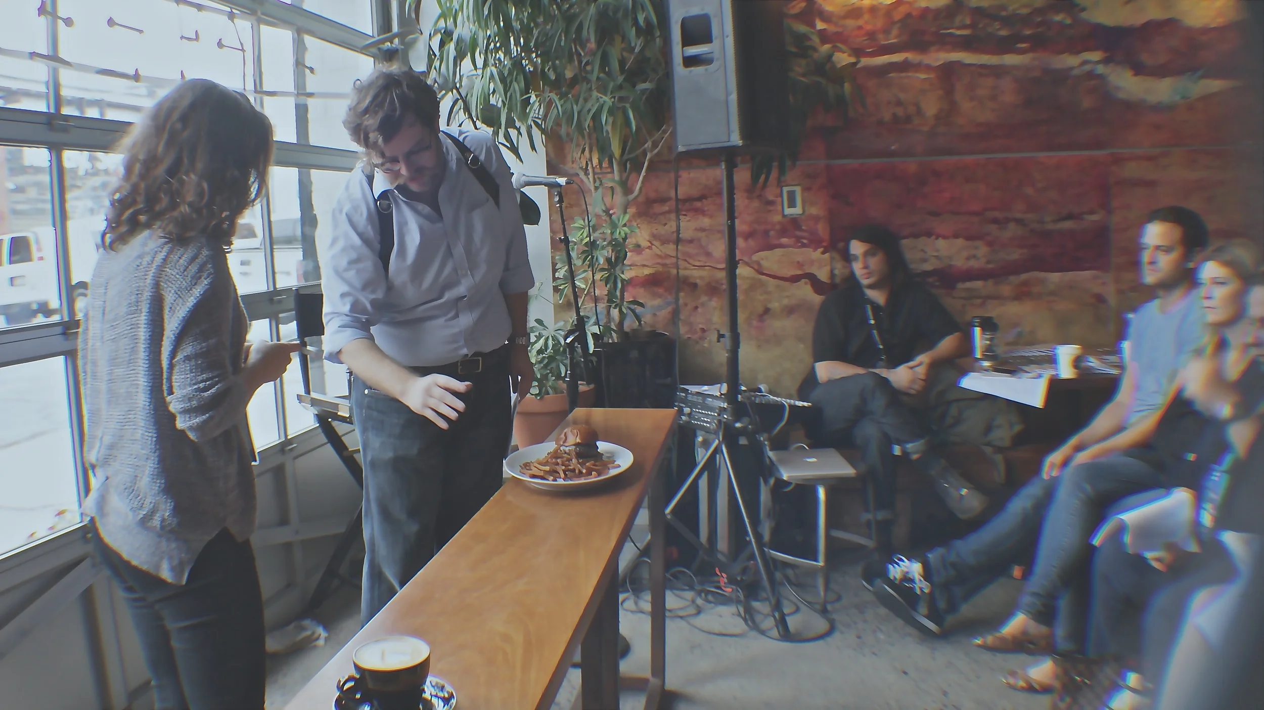 Dan Krieger teaches an audience member to practice food photography techniques.