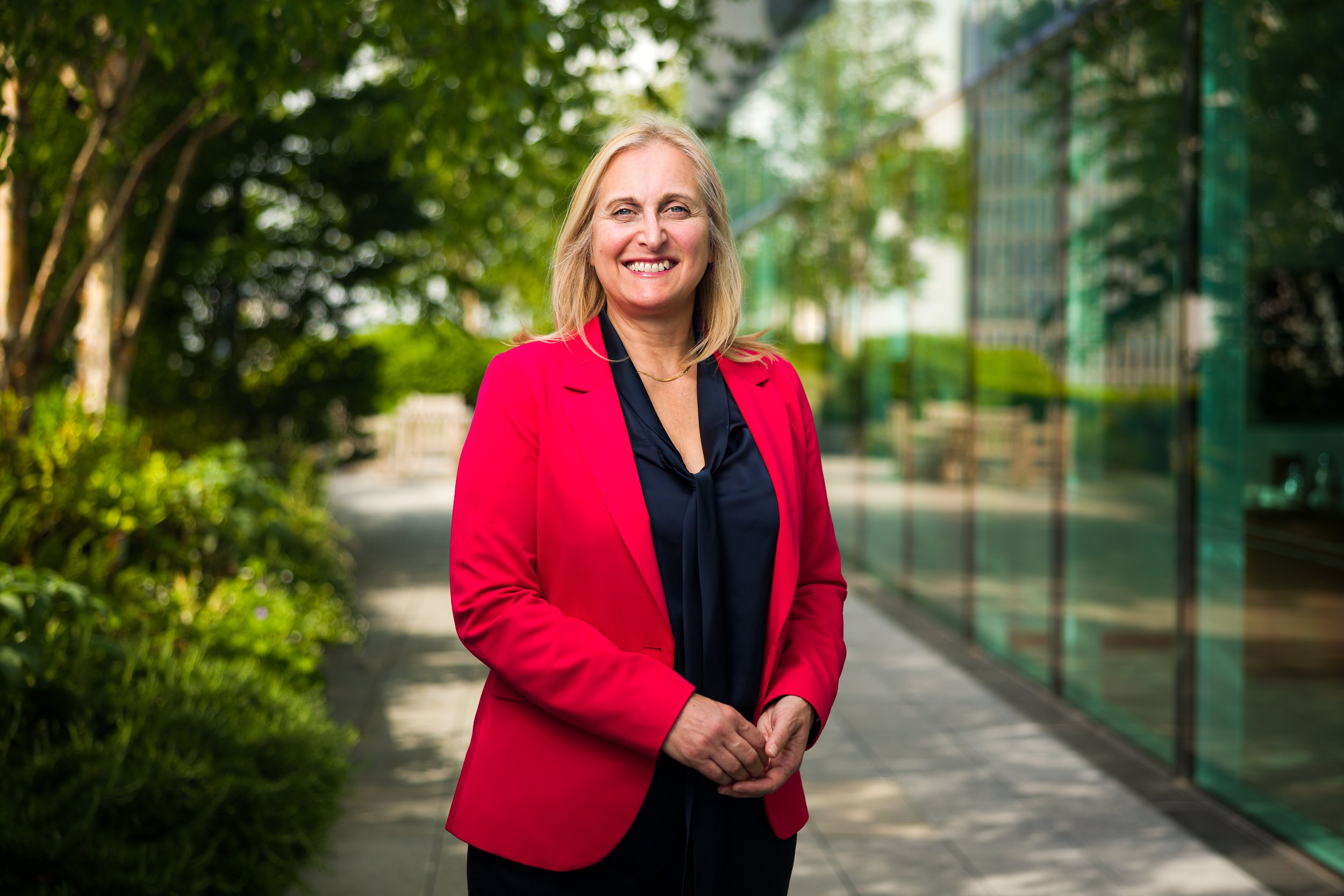 Outdoor portrait of a CEO wearing a red jacket