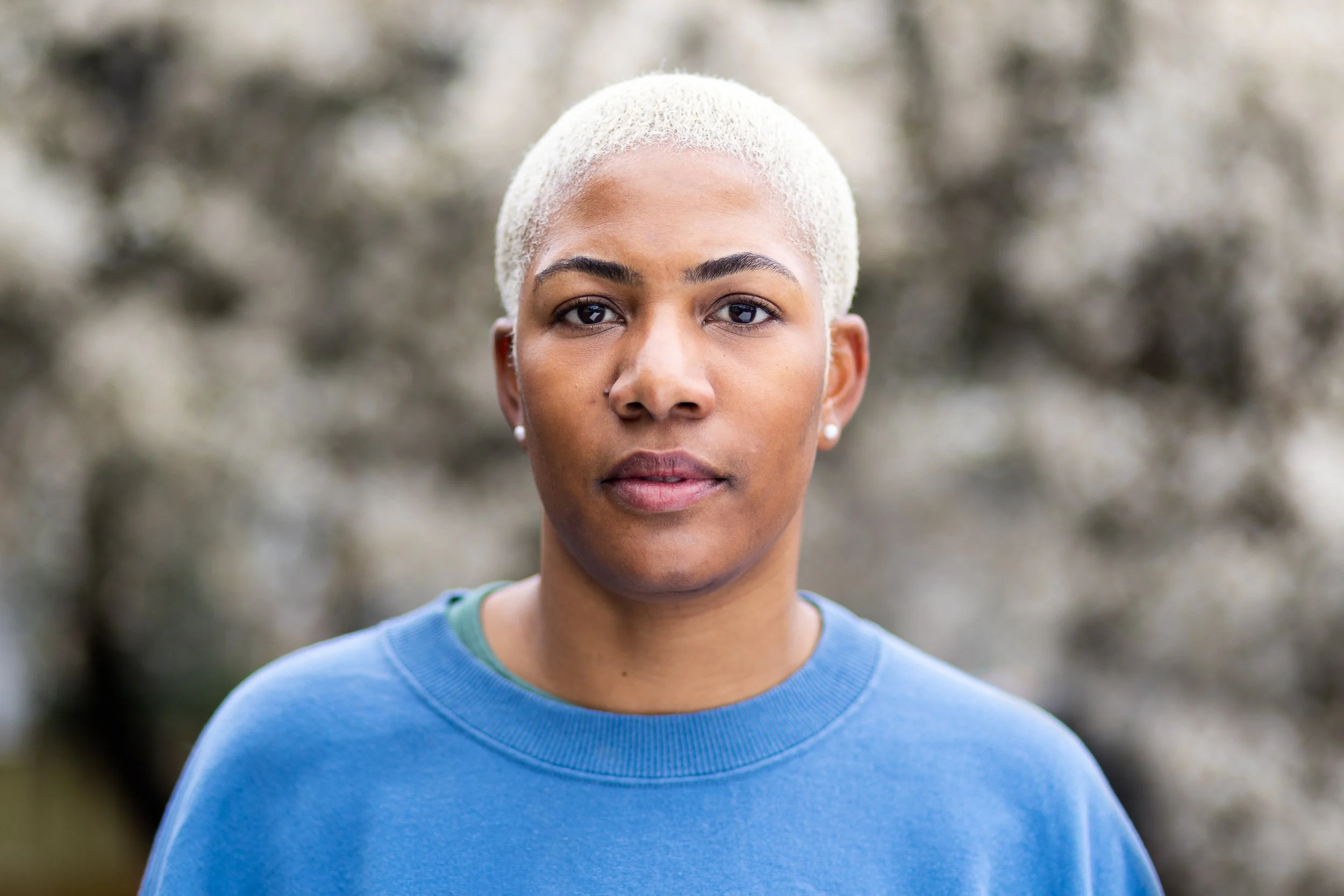 Headshot of a young woman in a park 