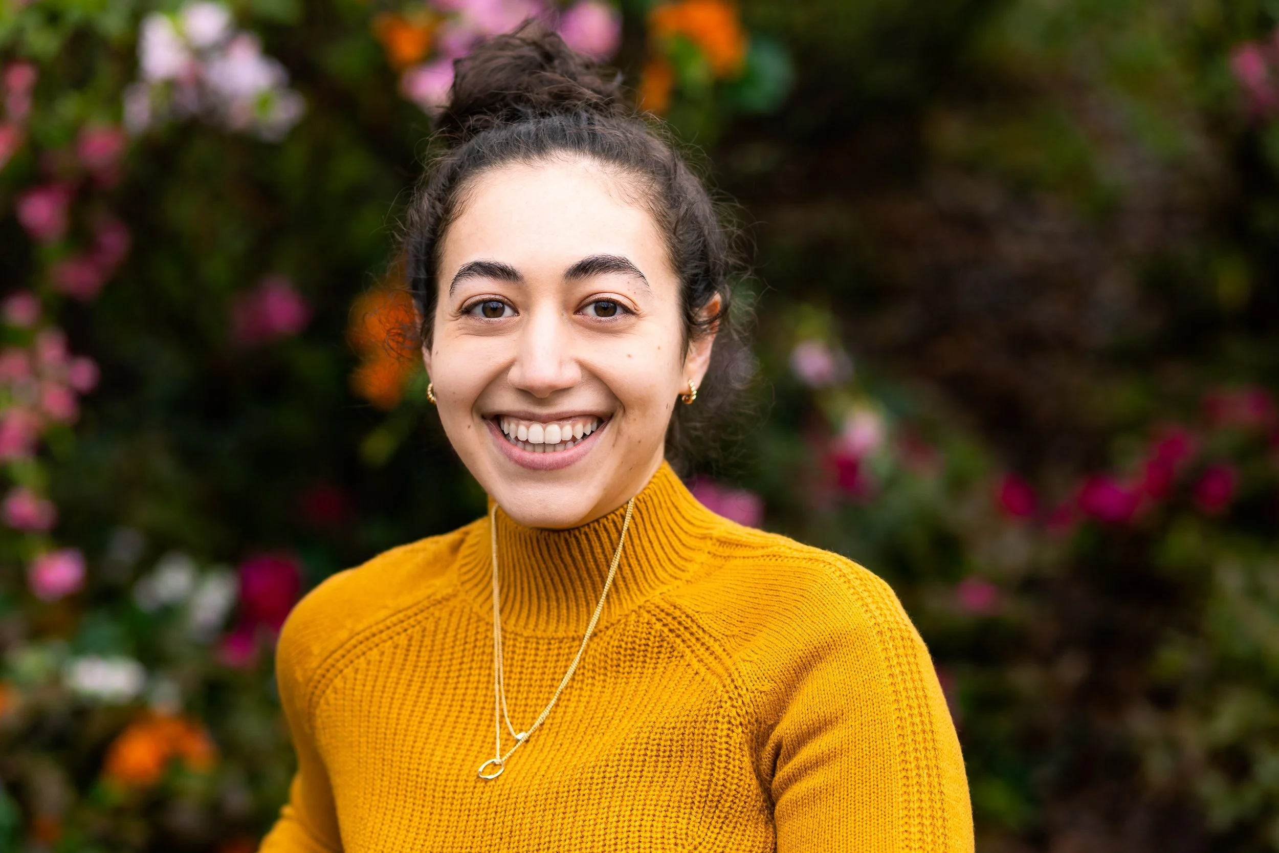 A young woman wearing yellow smiling