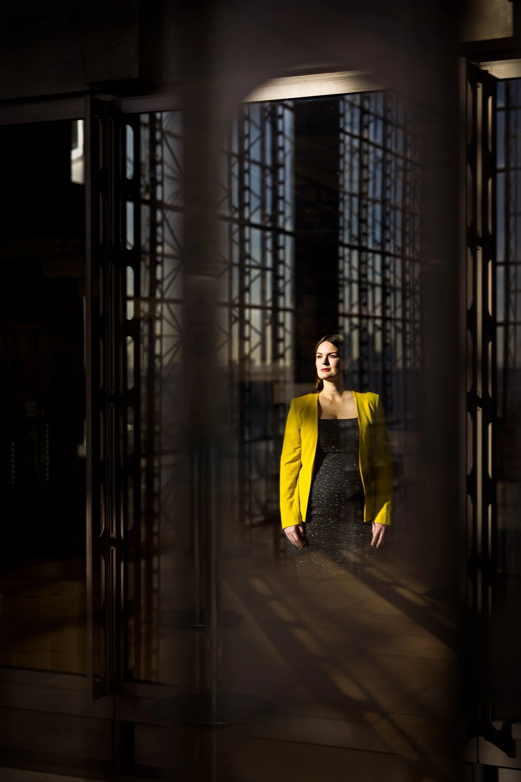 Portrait of a woman behind a full-length window in an office