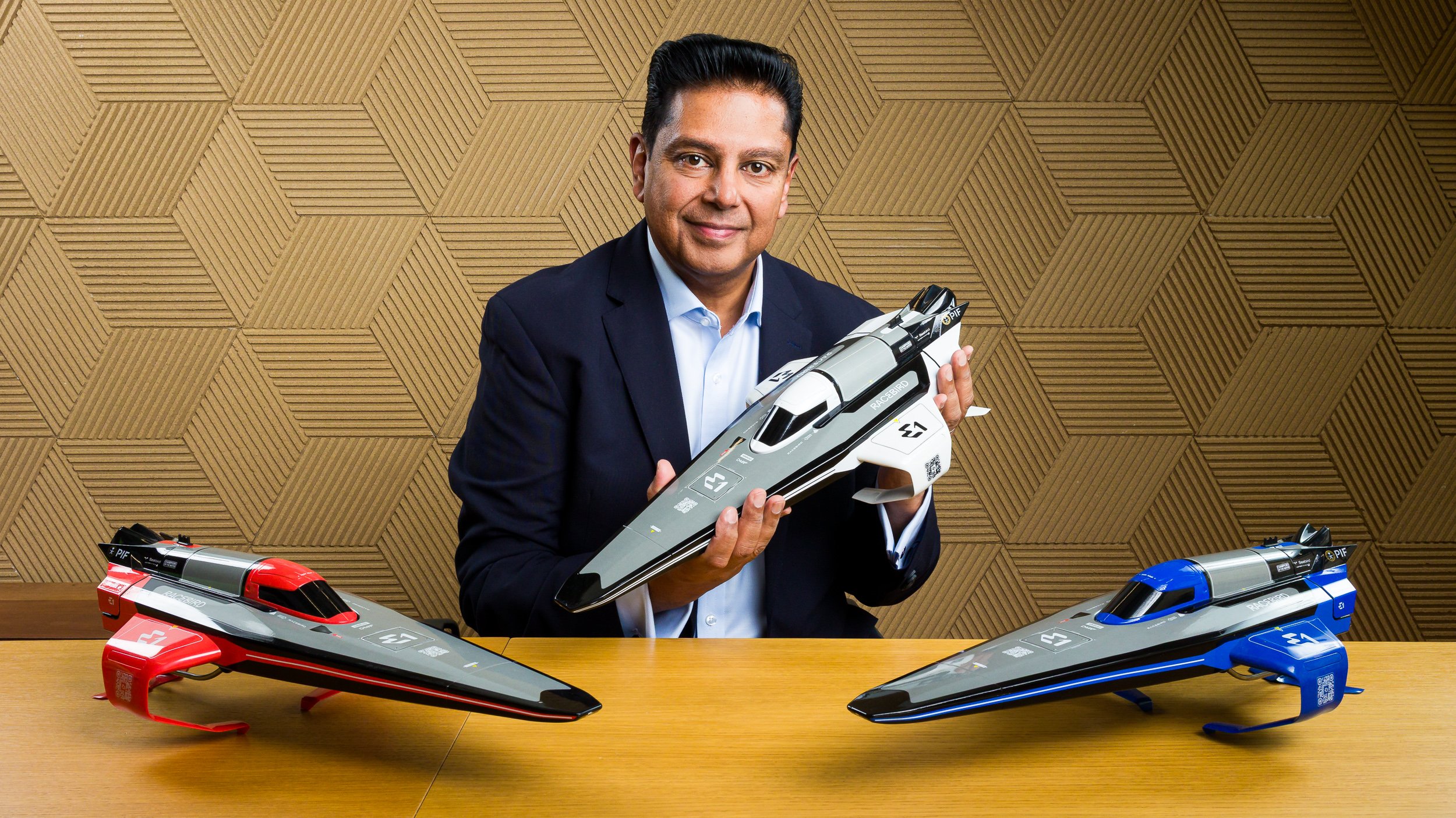 A man holds a model speedboat