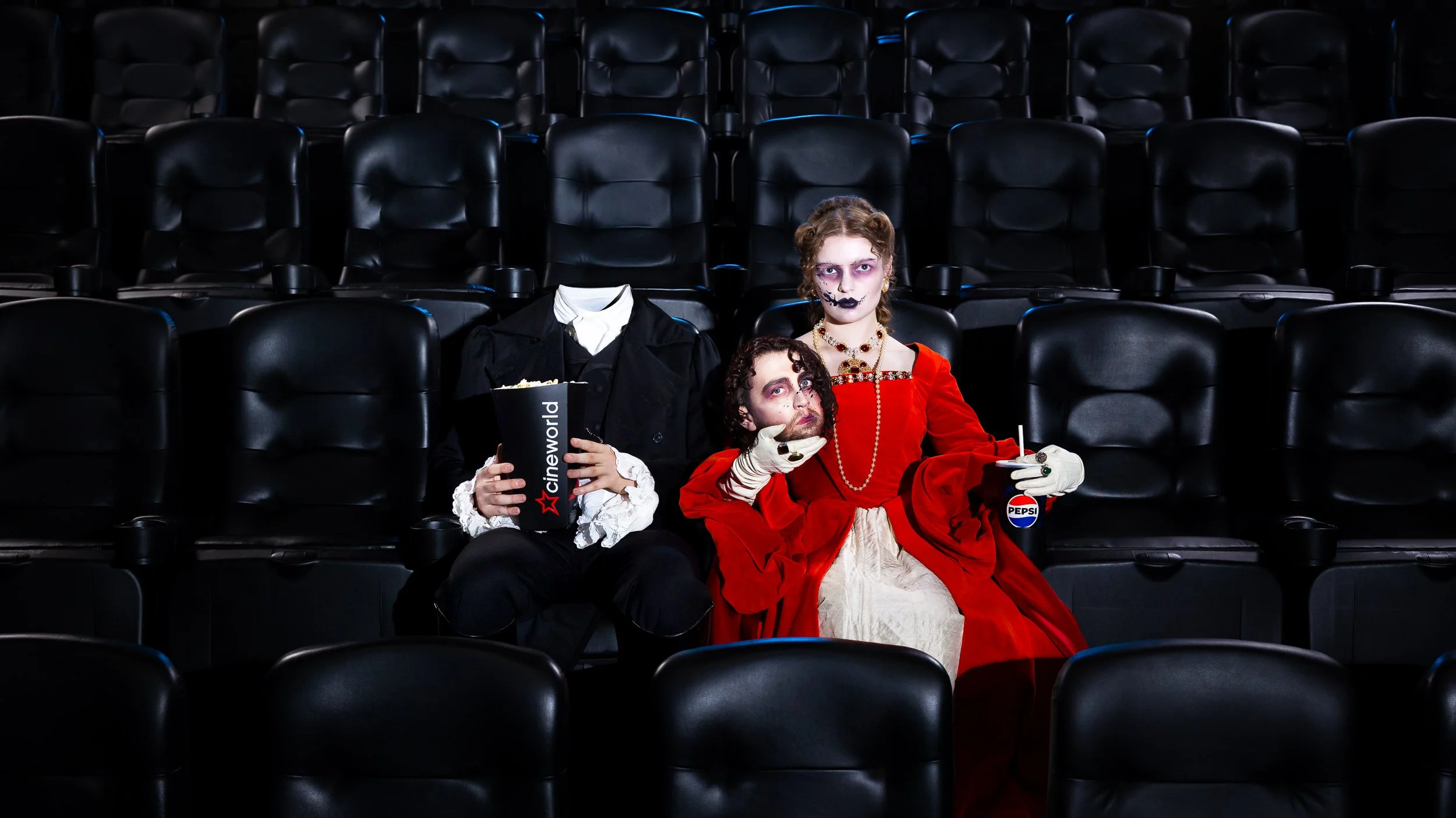 A headless man and his date watching a film in the cinema