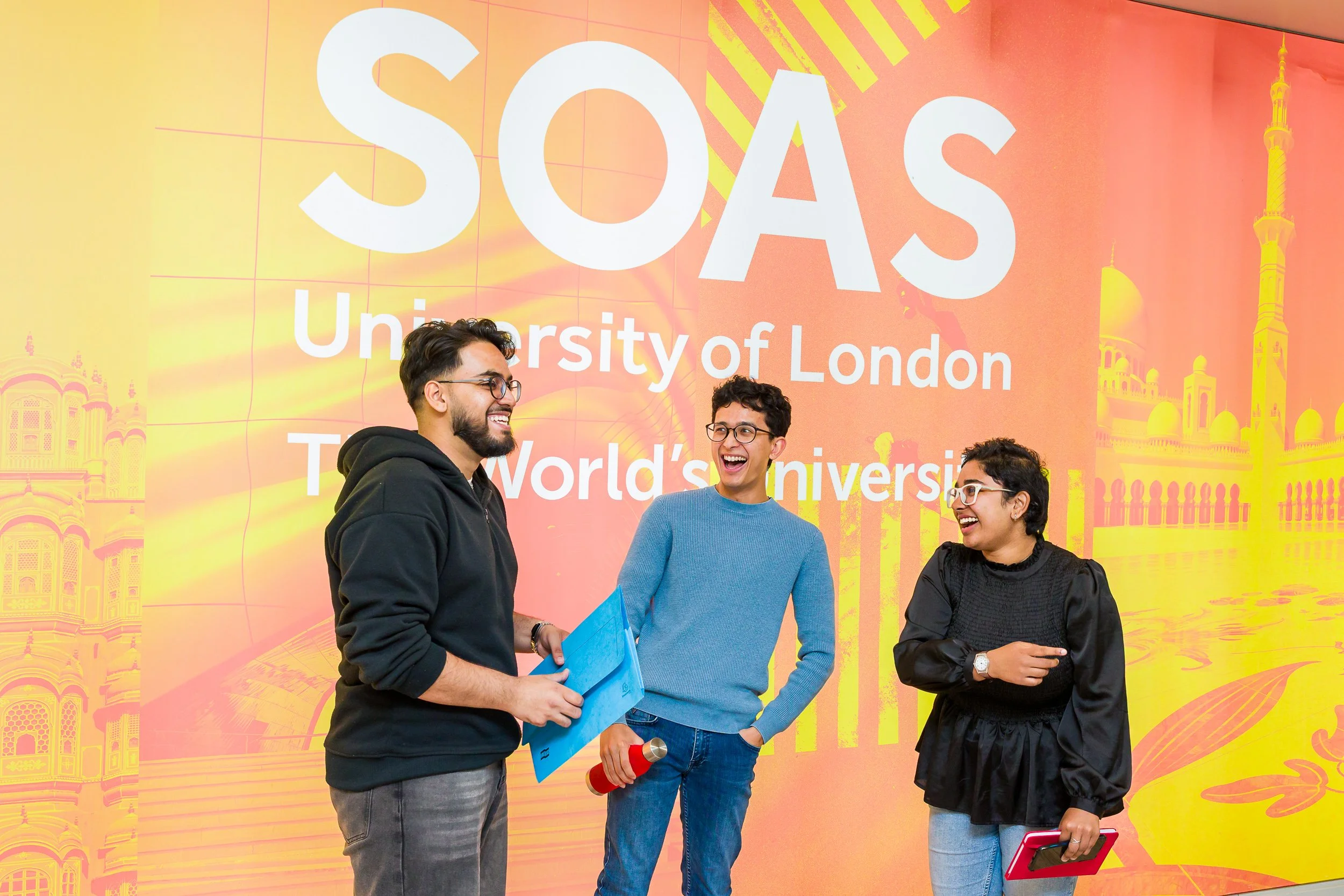 Prospectus image for SOAS of three students laughing