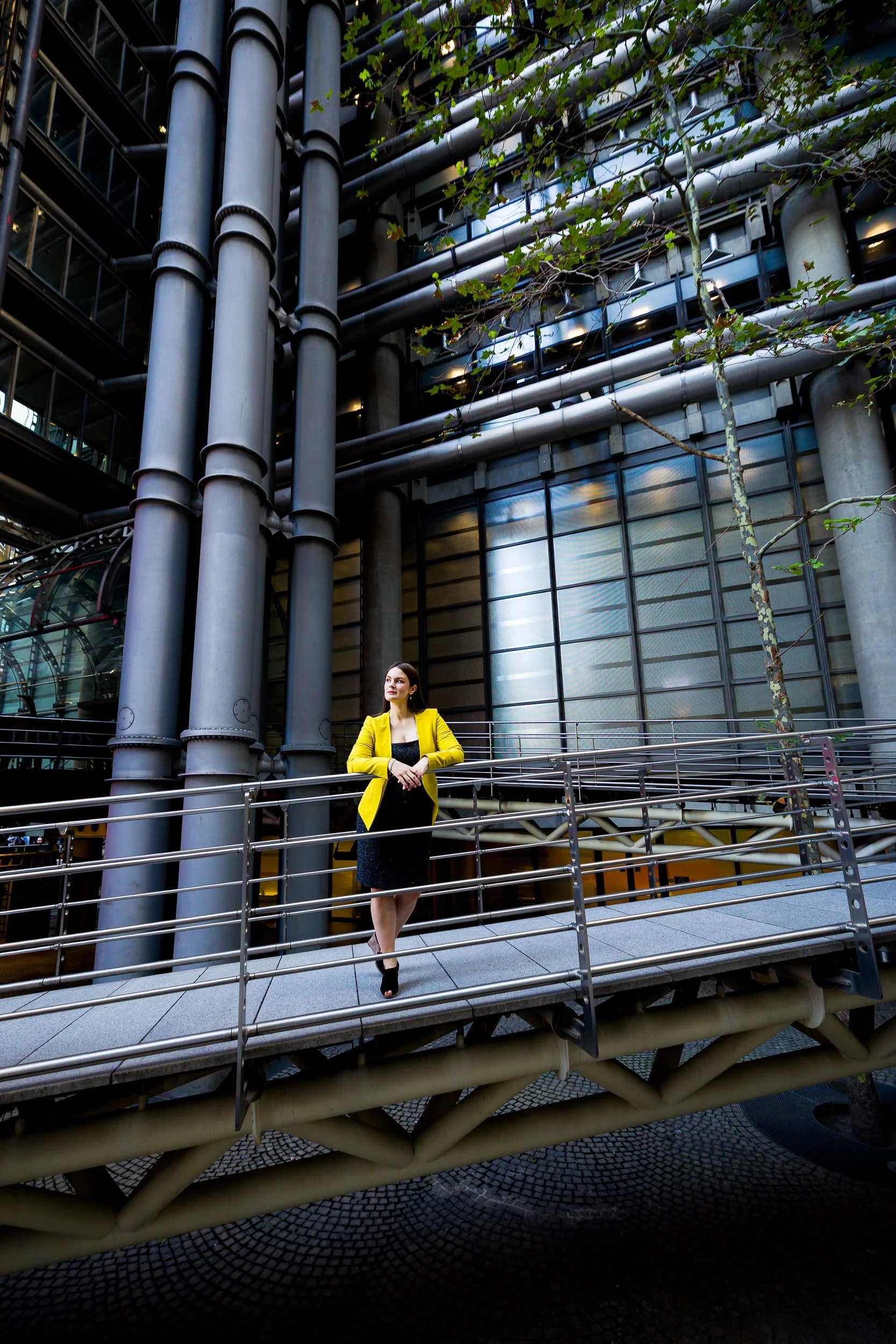 Portrait of a businesswoman in a yellow jacket in London, looking away from camera