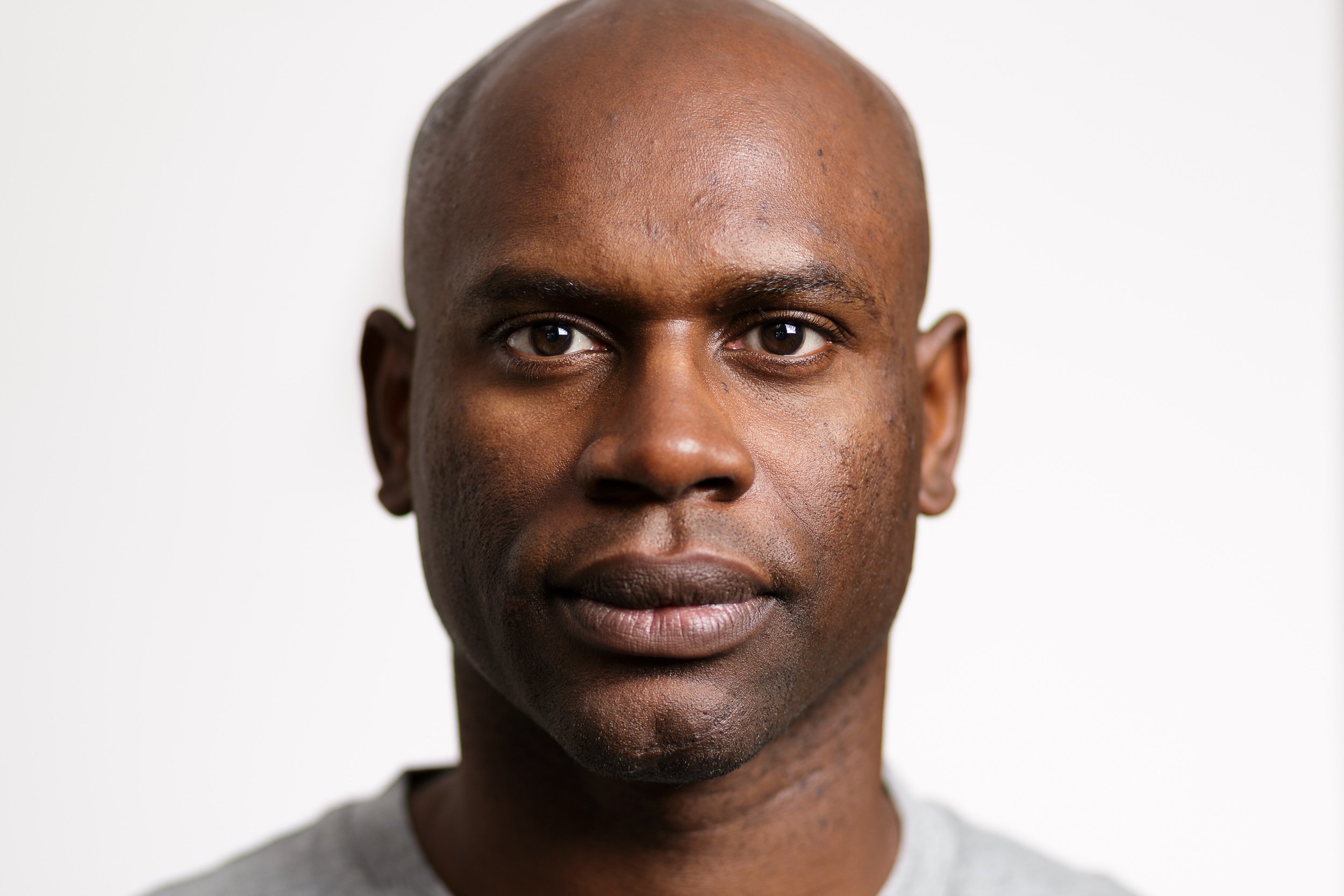 Headshot of a father against a plain background
