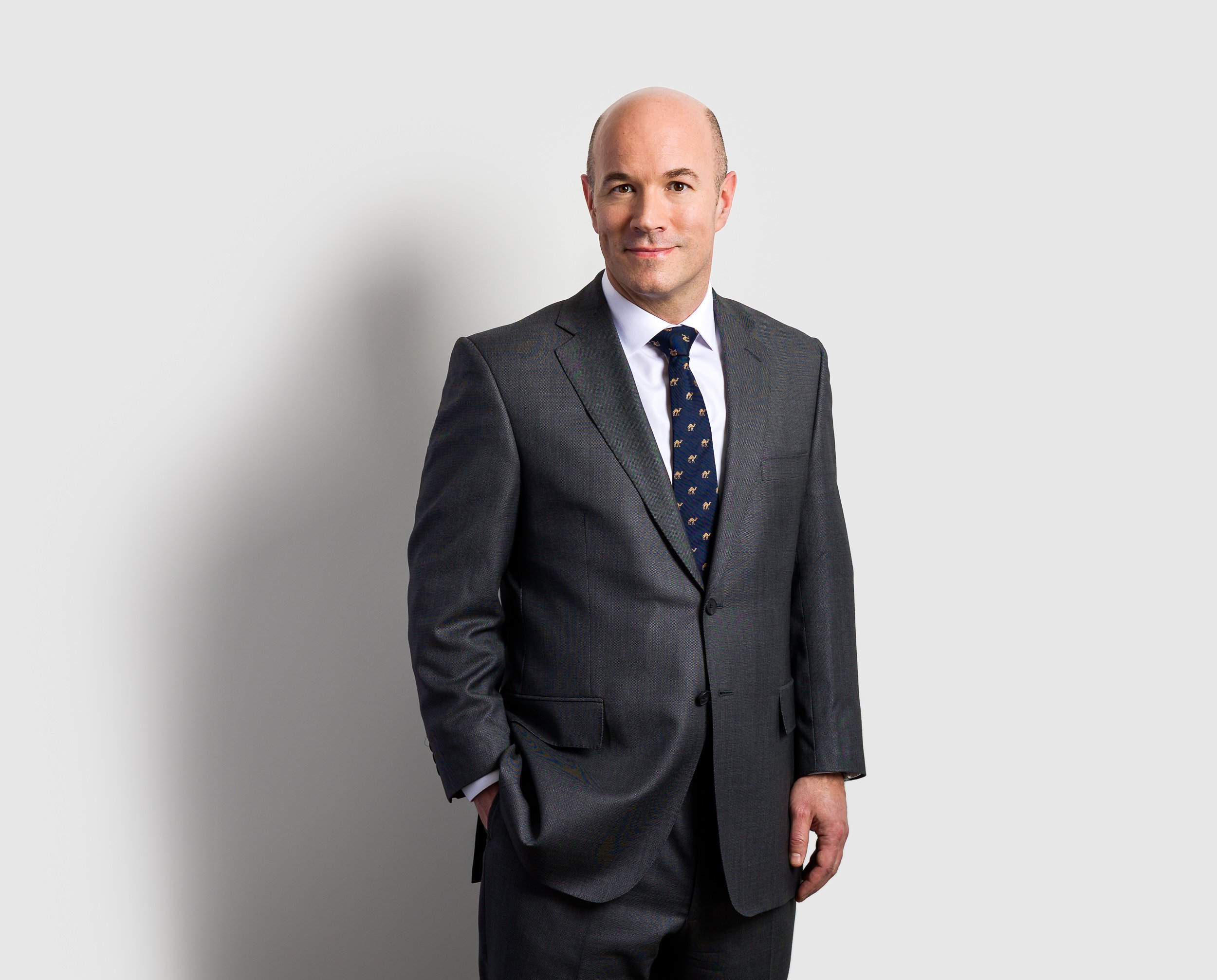 Half-length business portrait on a plain background