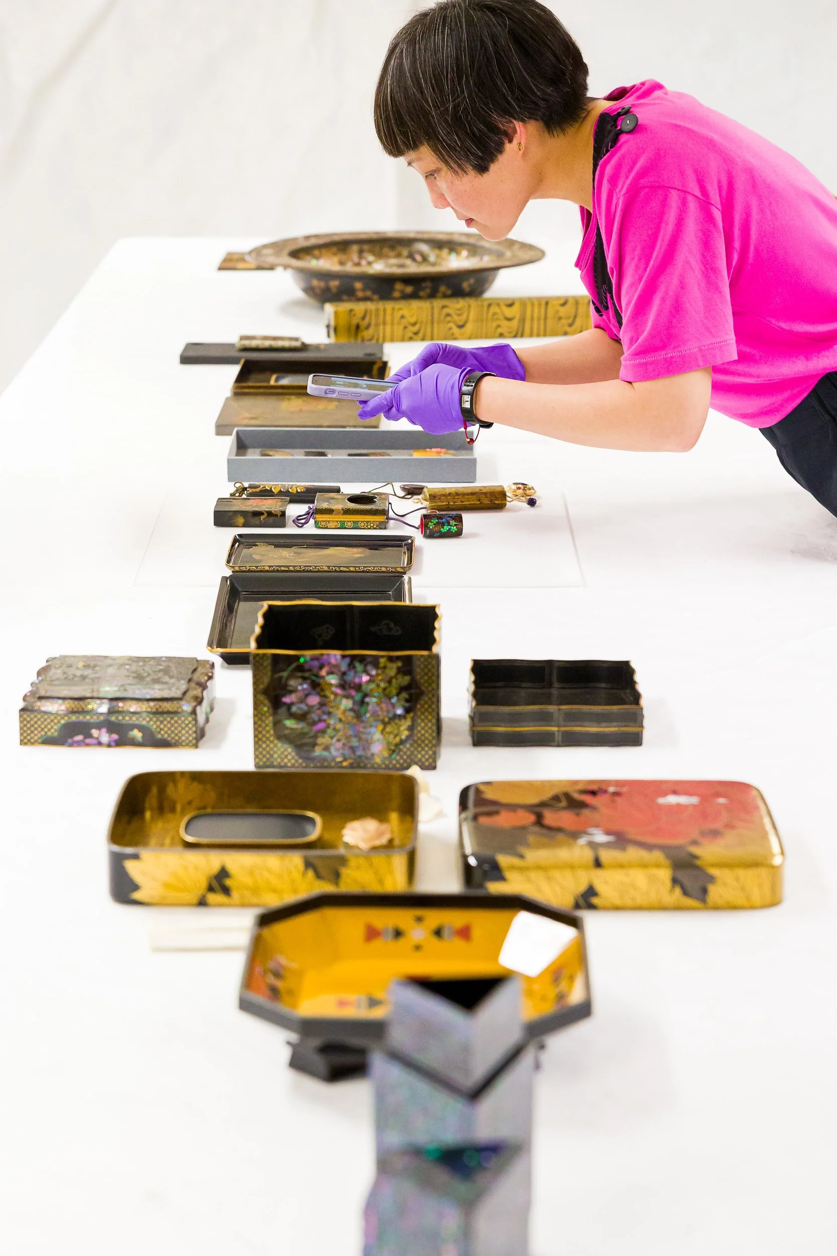 A student examining lacquerware at the V&A museum