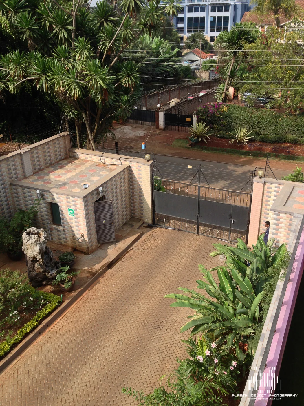 While waiting for our ride to the reception, I grabbed this shot of the gate and guard shack at our apartment. If you look closely you'll see the electric wires on top of the walls.