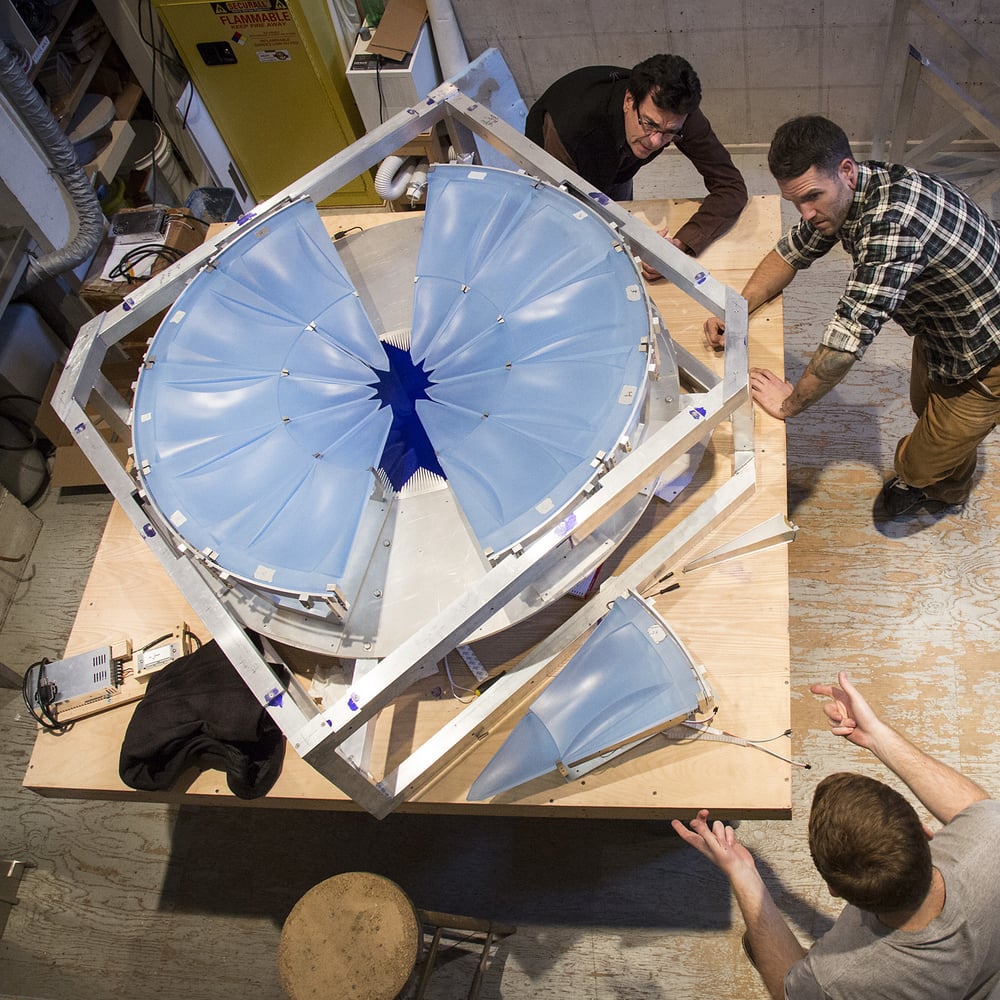   Clockwise from top:  Dan Dailey, Joe Wight, and Dana DiPlacido assemble the glass parts. 