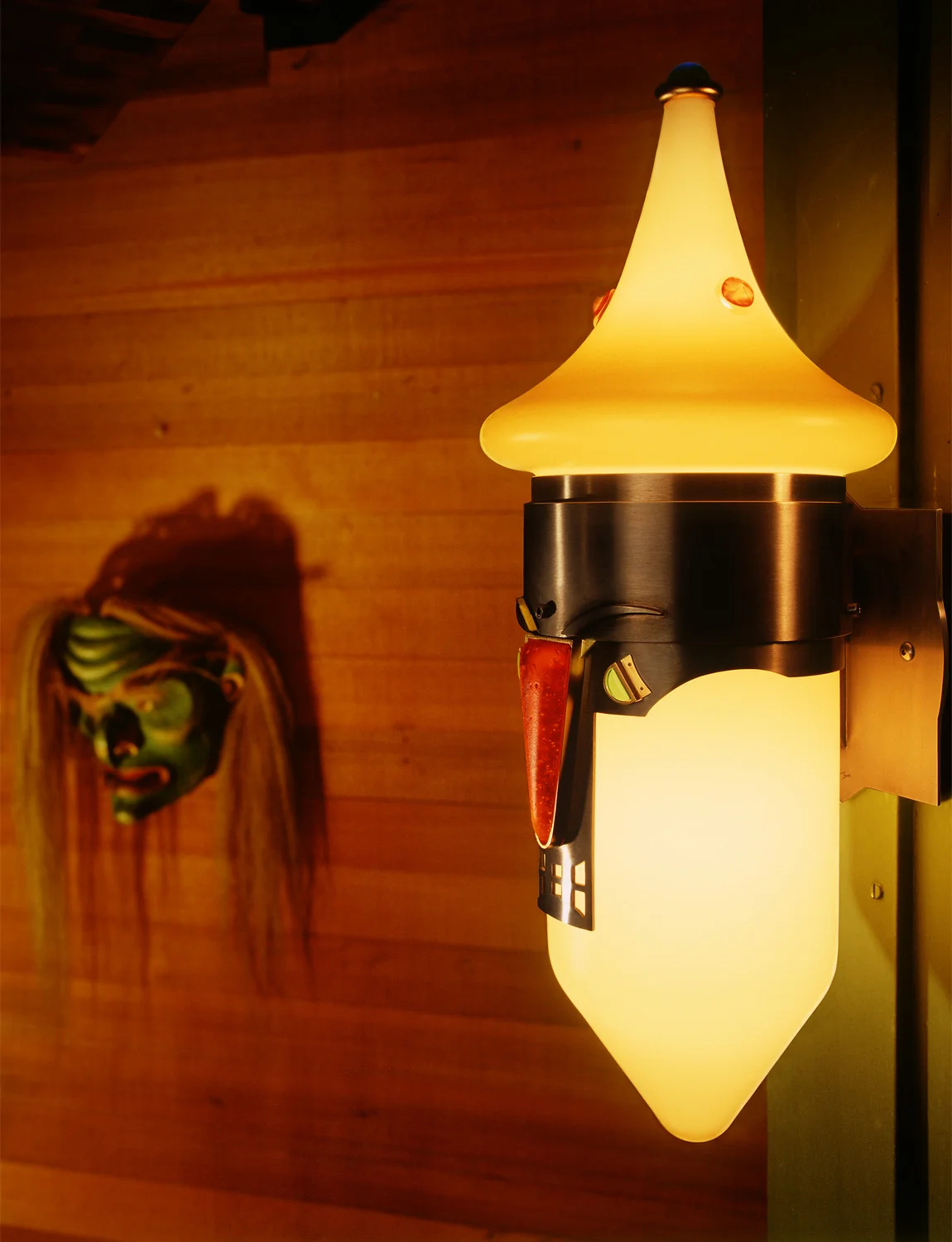 Mask Sconce 2001. (1 of 9) Cast glass, nickel and gold plated bronze. 16 x 6½ x 7½" Private residence, Long Beach, CA