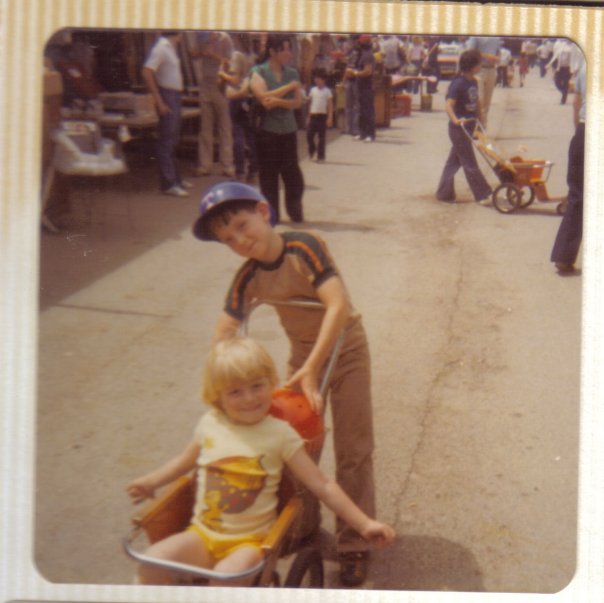 My cousin, Josh, pushing my stroll at the Texas State Fair sometime in the late 70s. That is a really large acorn on my shirt. 