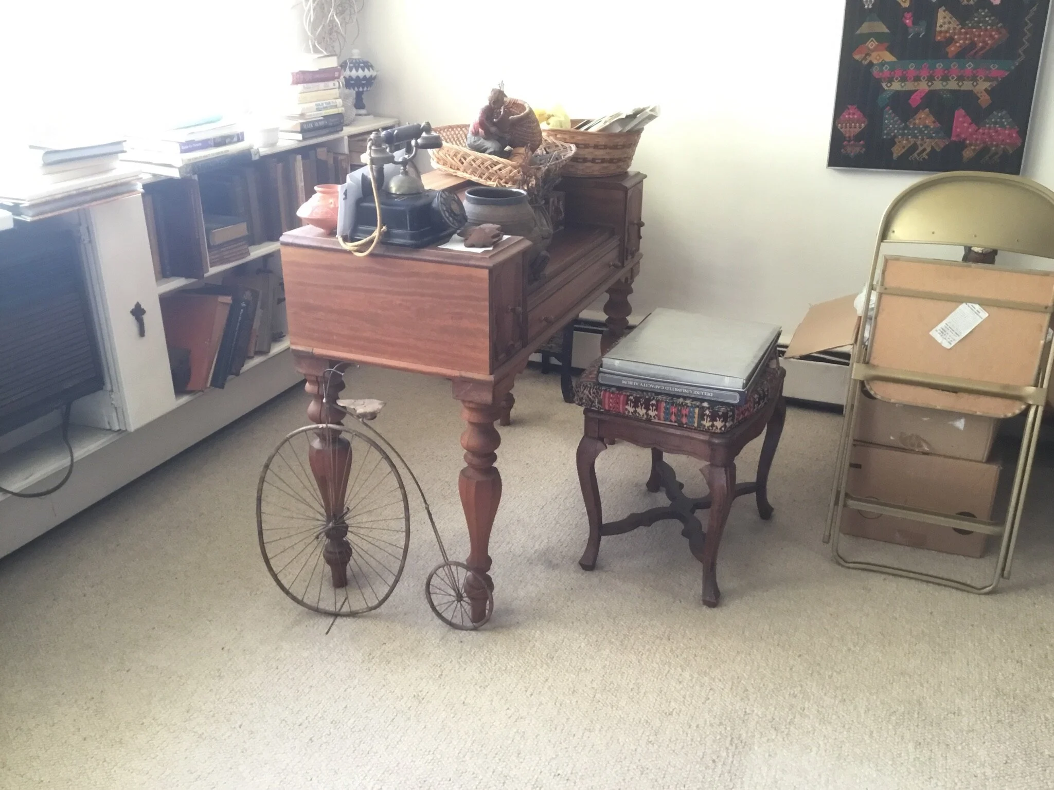 Pennyfarthing sculpture with writing desk and bench with books