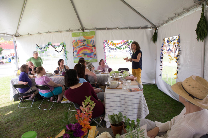 Kirsten taught kraut making to a couple rounds of enthusiastic folks in the Taproot Magazine tent at the Mother Earth News Fair in Vermont . Everyone was so excited to take home their very own jar to tend to on their counter. Photo by Amanda Blake Soule.