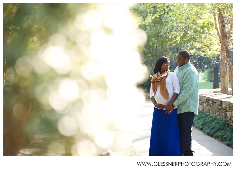 Expectant parents Kamisha and Adrian pose for their maternity portraits taken by High Point-based family photographer Glessner Photography at Tanger Family Bicentennial Gardens in Greensboro.