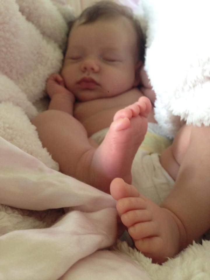 Baby Siena snoozing while her mom happily snaps pictures of these delicious little feet!