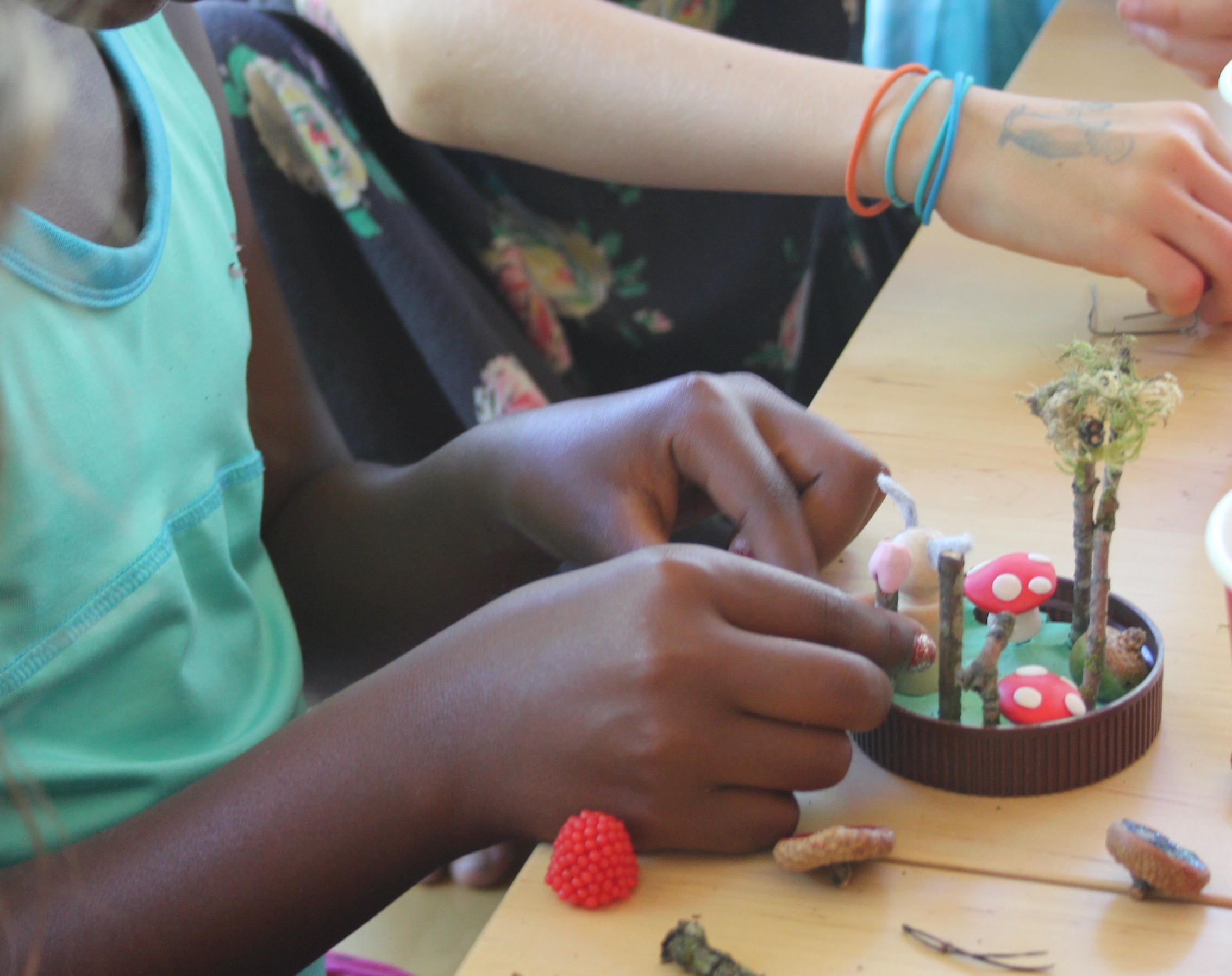 4. Have your party guests choose a jar, any clear one will do (these are plastic nut butter jars). Smush some modeling clay into the lid and start creating a mini woodland terrarium.